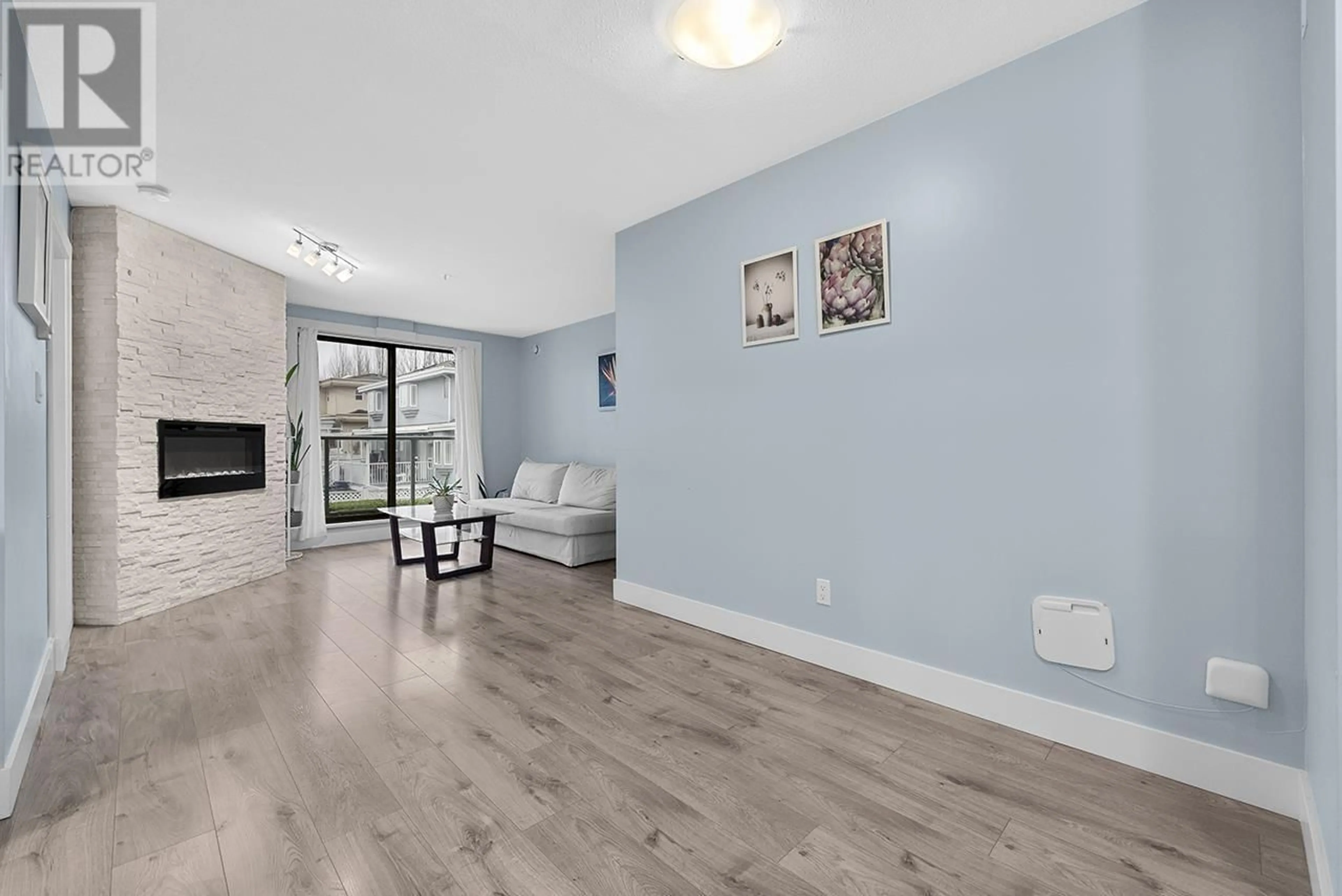 Living room with furniture, wood/laminate floor for 211 - 5818 LINCOLN STREET, Vancouver British Columbia V5R4P7
