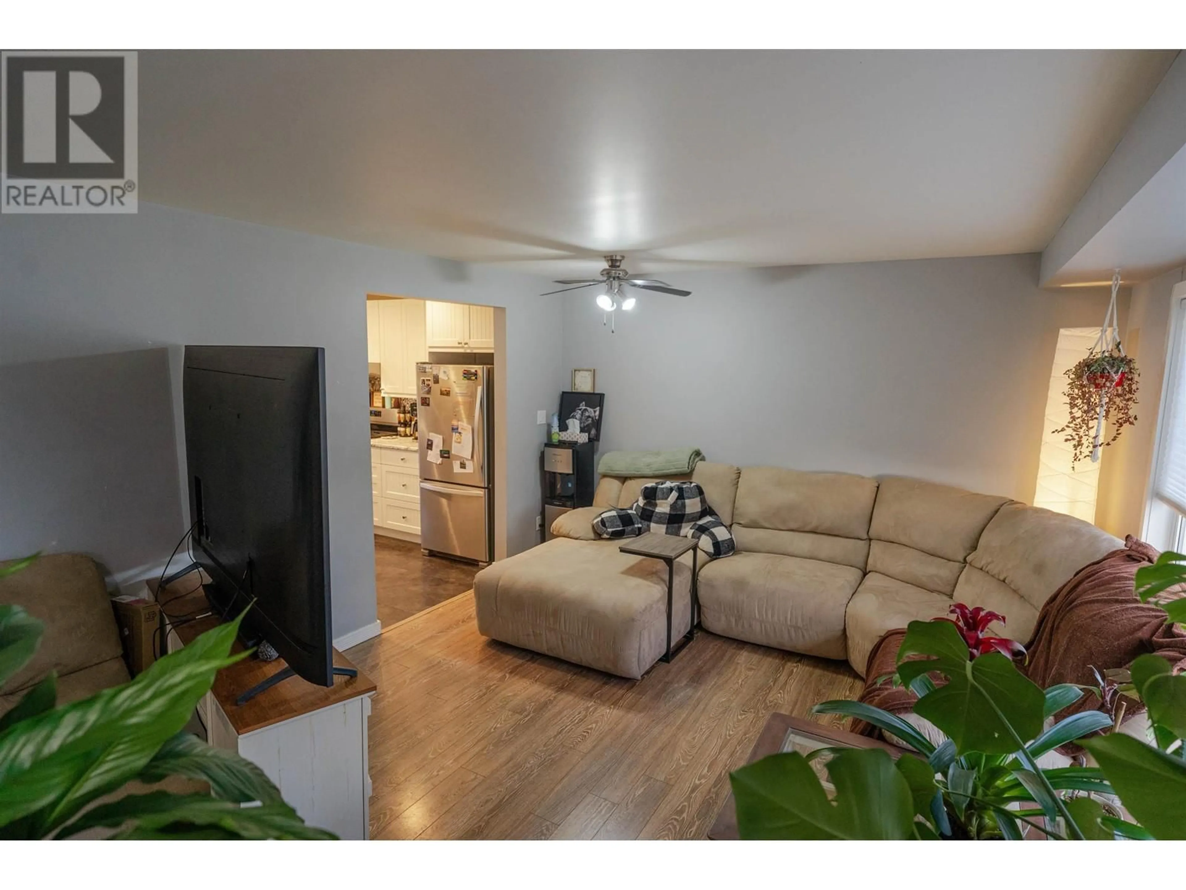 Living room with furniture, wood/laminate floor for 9812 102 AVENUE, Fort St. John British Columbia V1J2E1