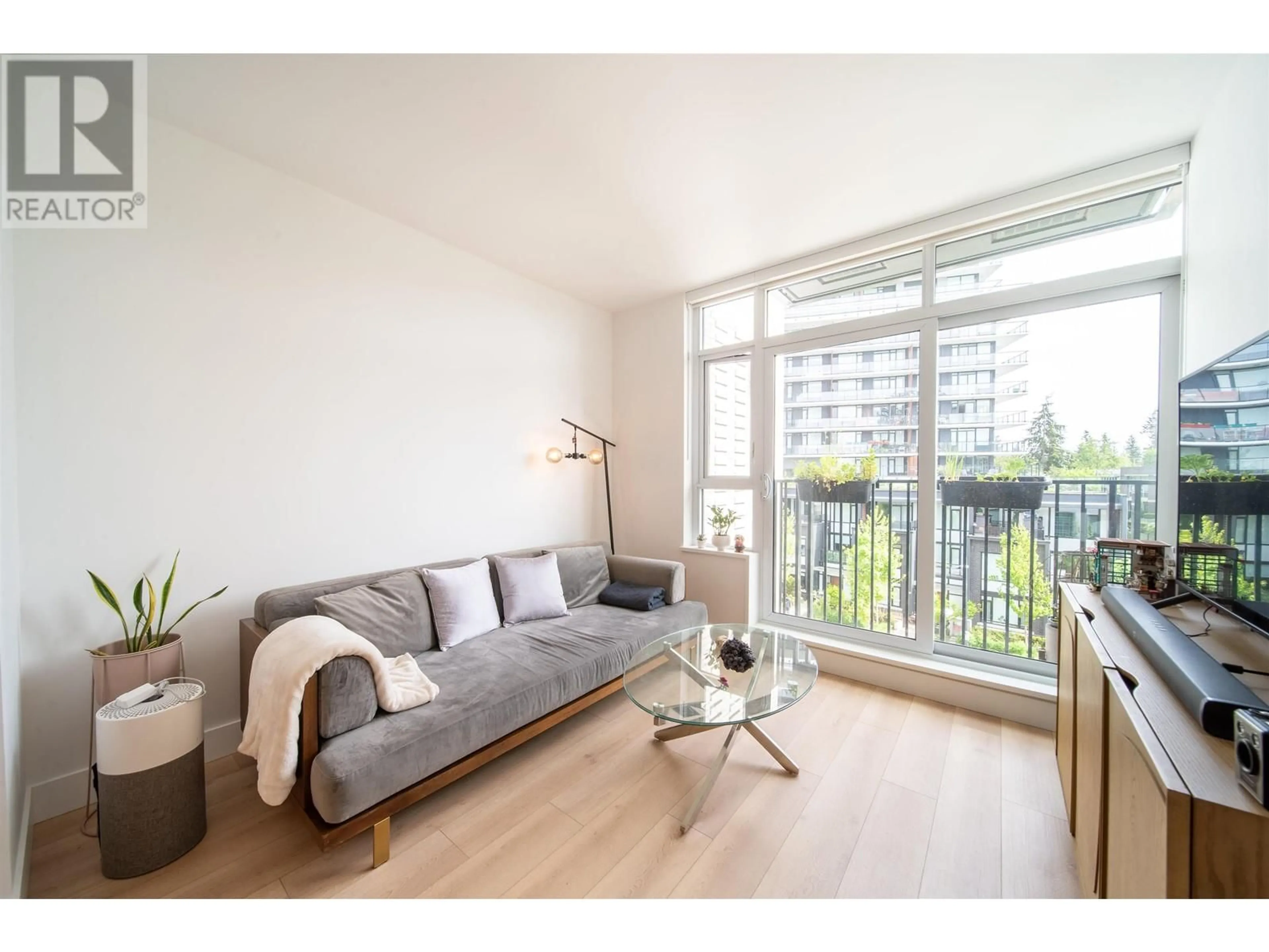 Living room with furniture, wood/laminate floor for 509 - 8750 UNIVERSITY CRESCENT, Burnaby British Columbia V5A0G9
