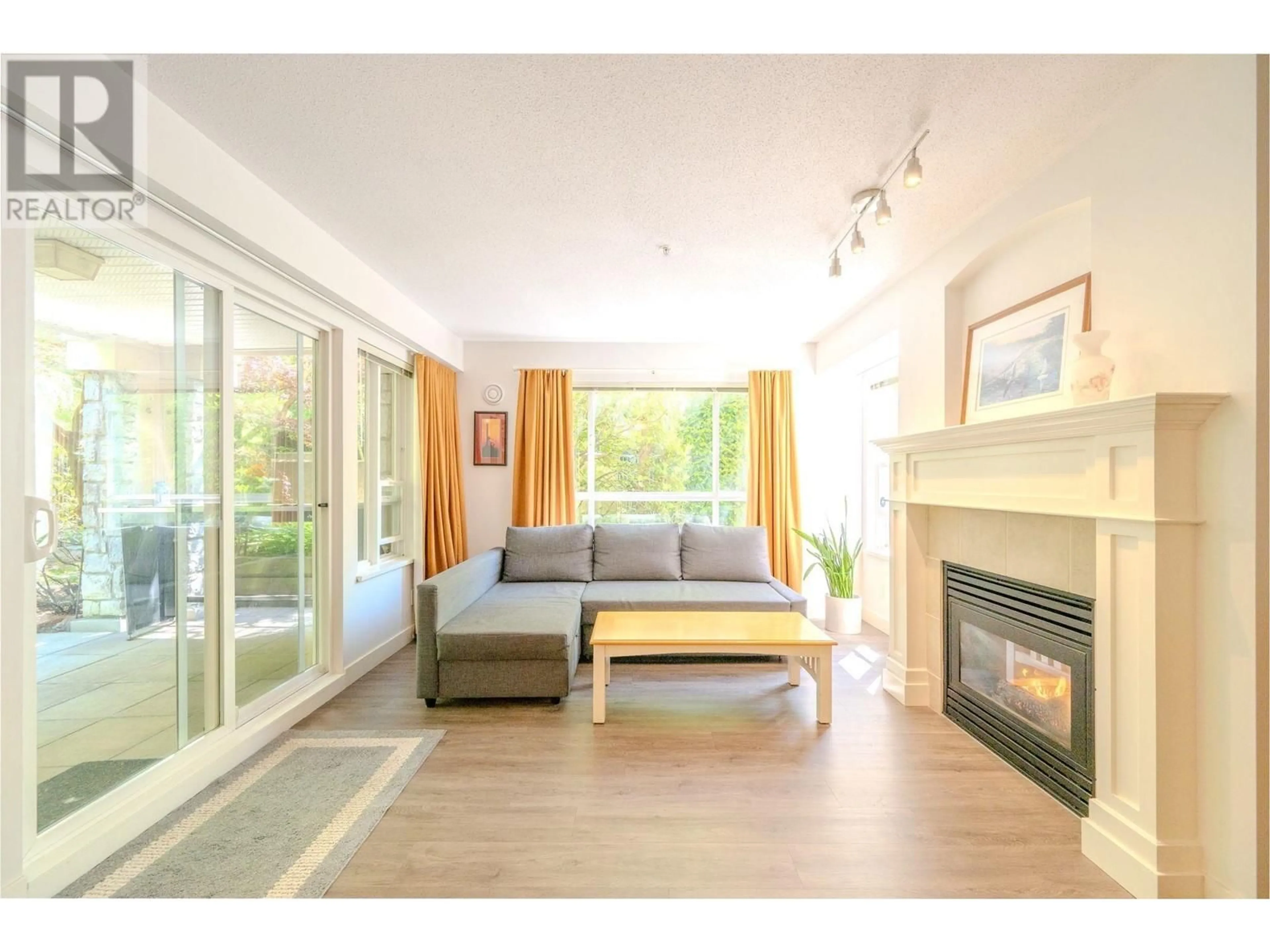 Living room with furniture, wood/laminate floor for 115 - 333 1ST STREET, North Vancouver British Columbia V7L4W9