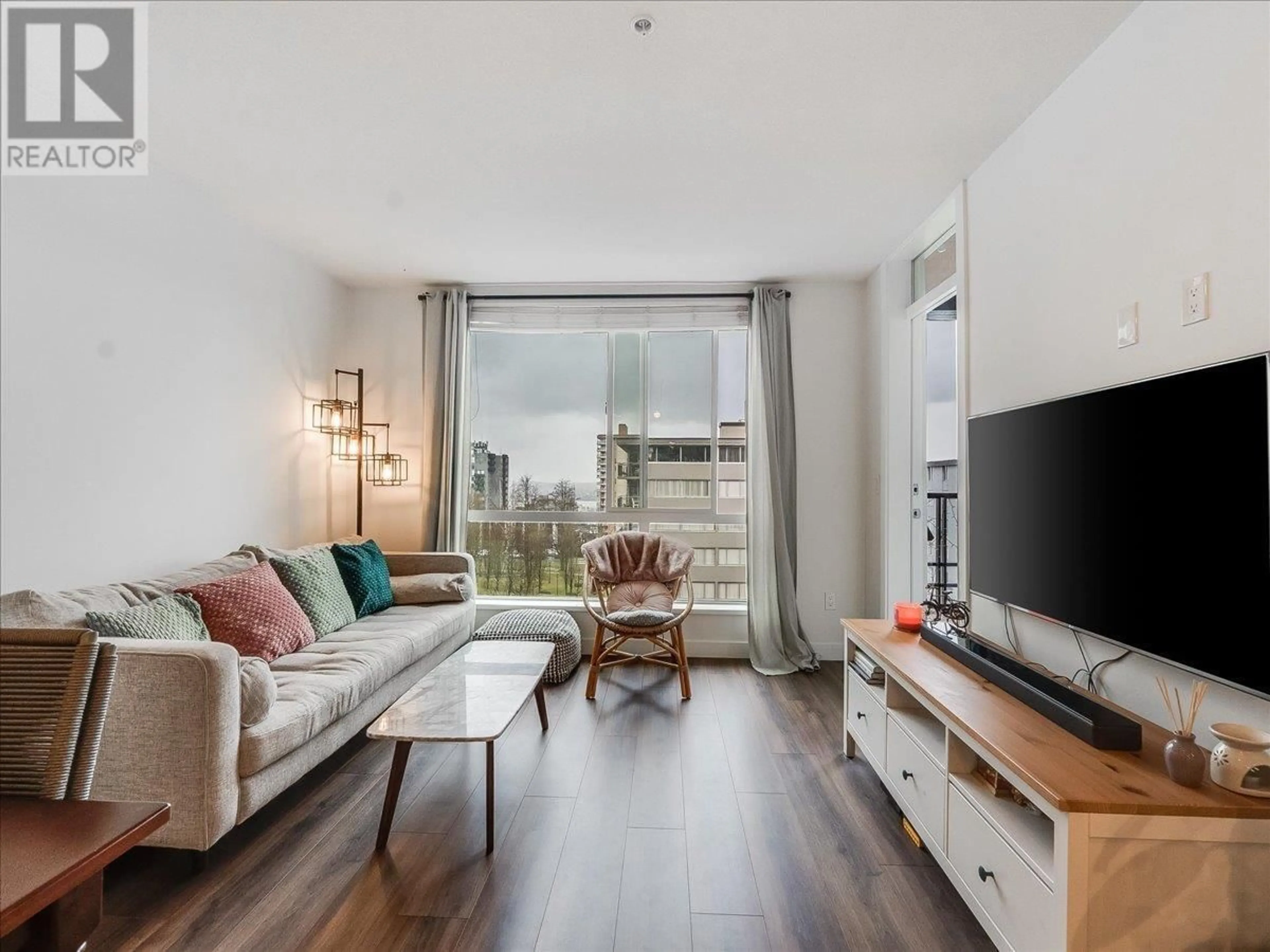 Living room with furniture, wood/laminate floor for 406 - 108 8TH STREET, North Vancouver British Columbia V7L0H1