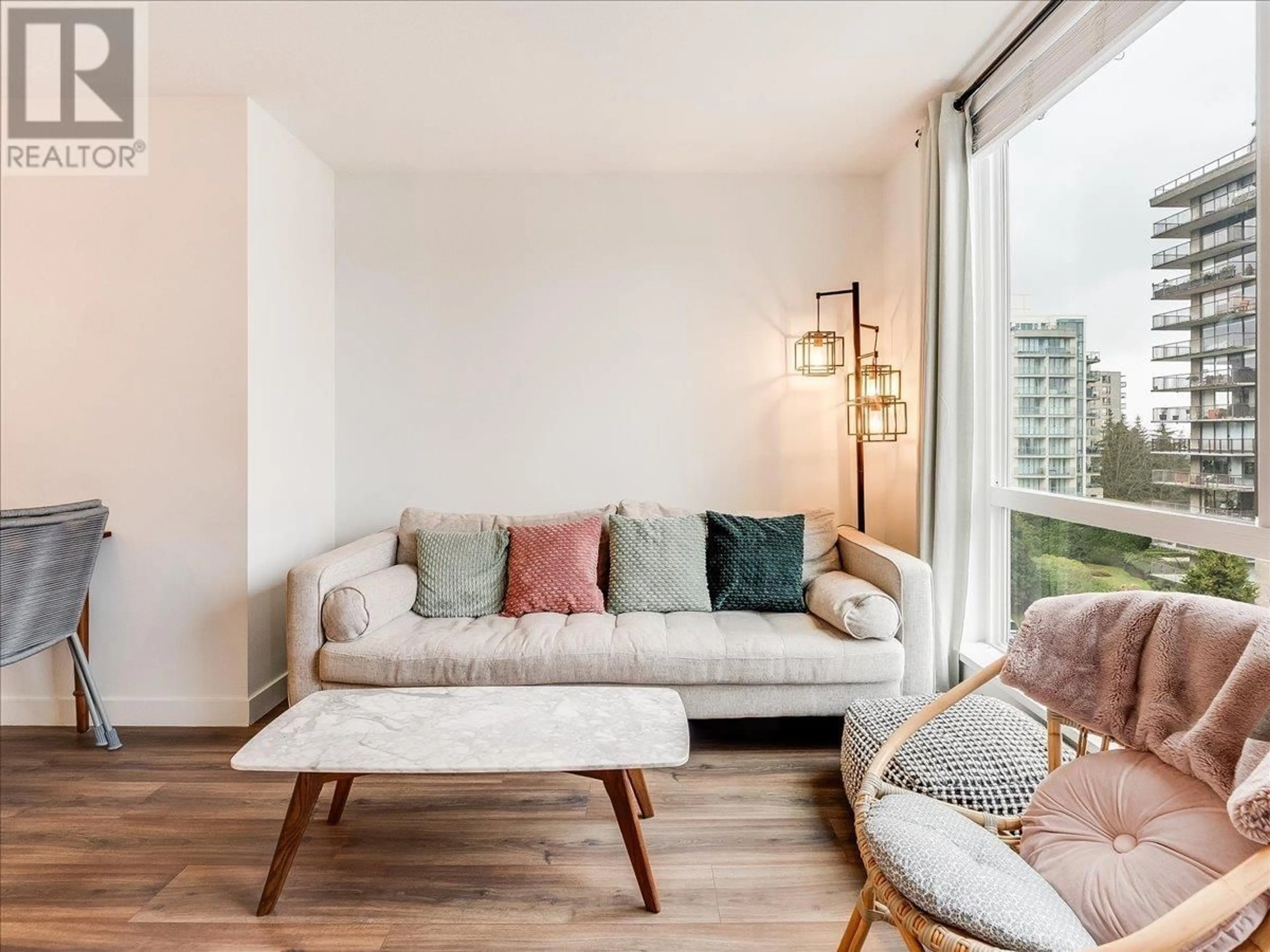 Living room with furniture, wood/laminate floor for 406 - 108 8TH STREET, North Vancouver British Columbia V7L0H1