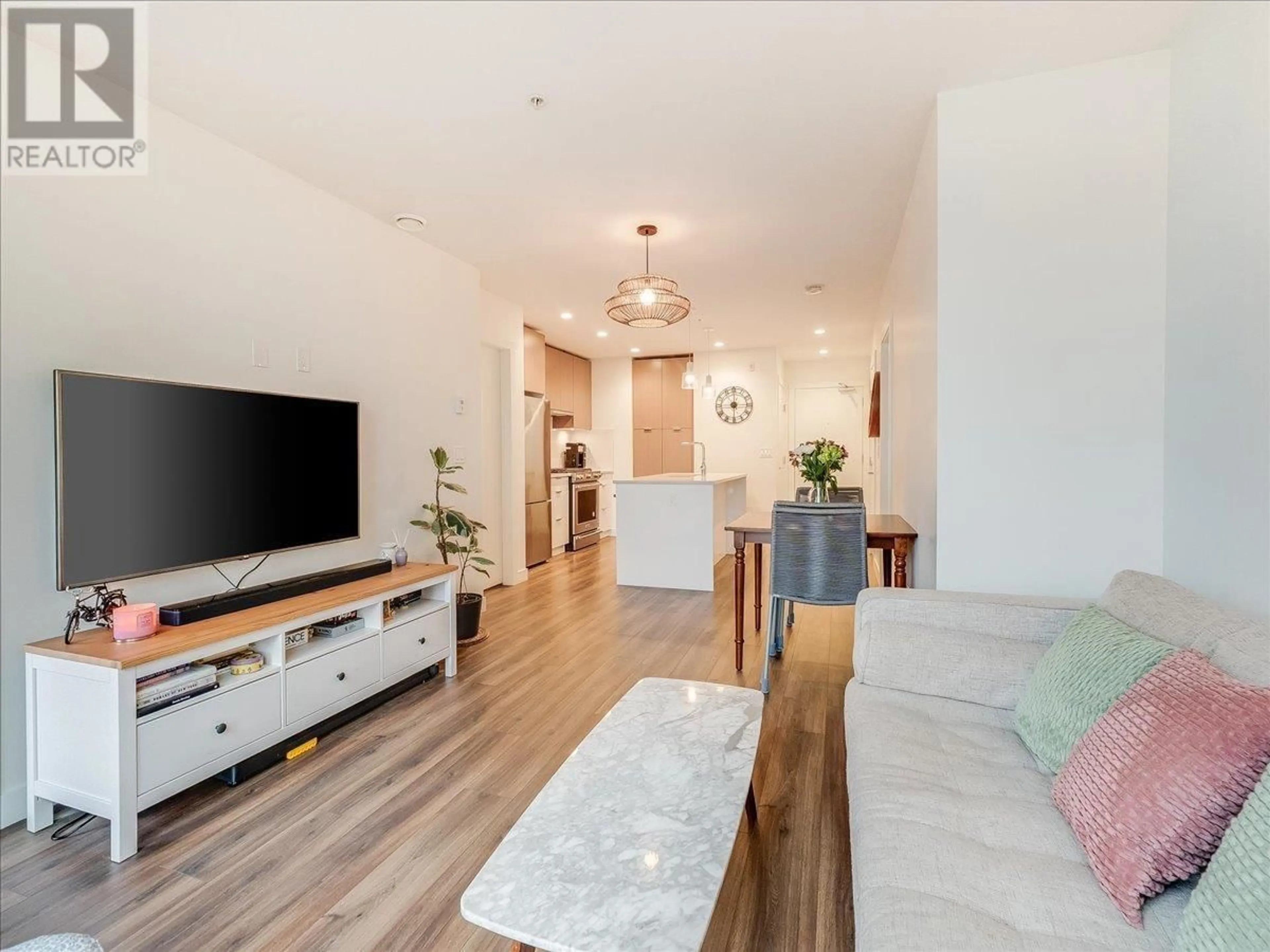 Living room with furniture, wood/laminate floor for 406 - 108 8TH STREET, North Vancouver British Columbia V7L0H1