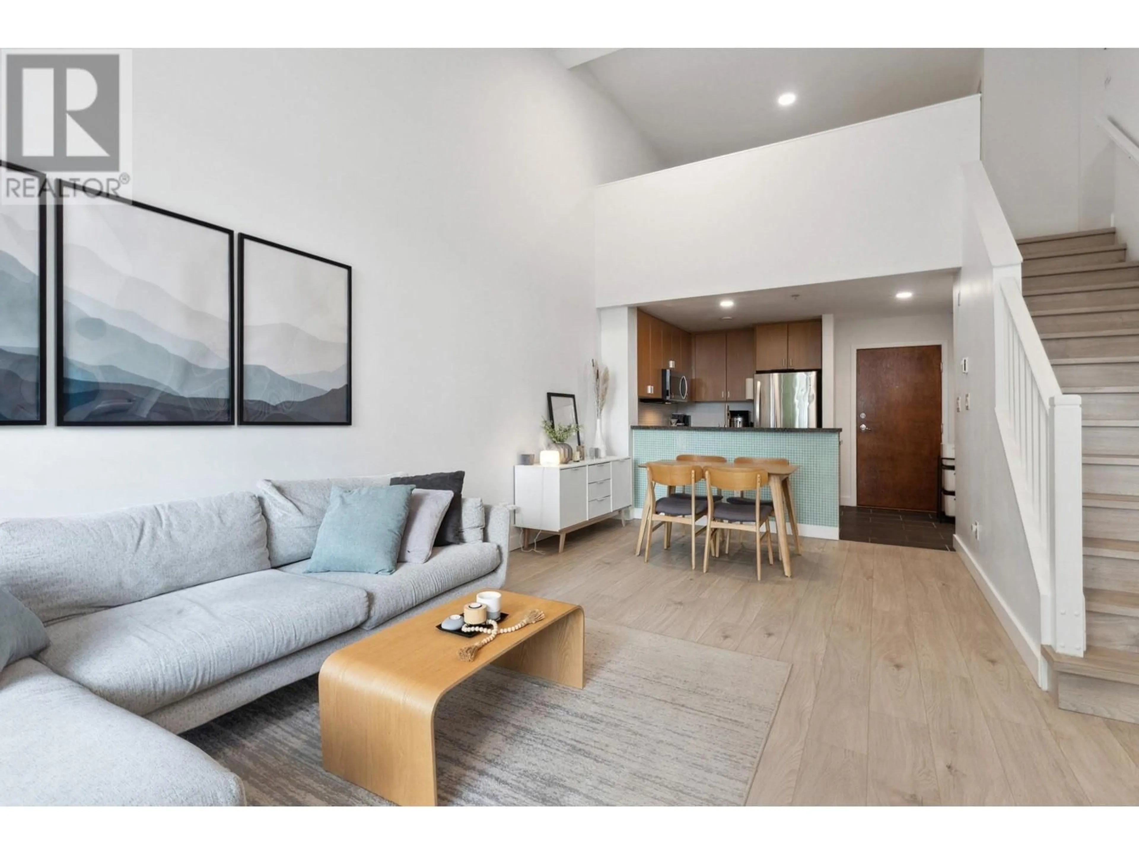Living room with furniture, wood/laminate floor for 402 - 6888 SOUTHPOINT DRIVE, Burnaby British Columbia V3N5E3