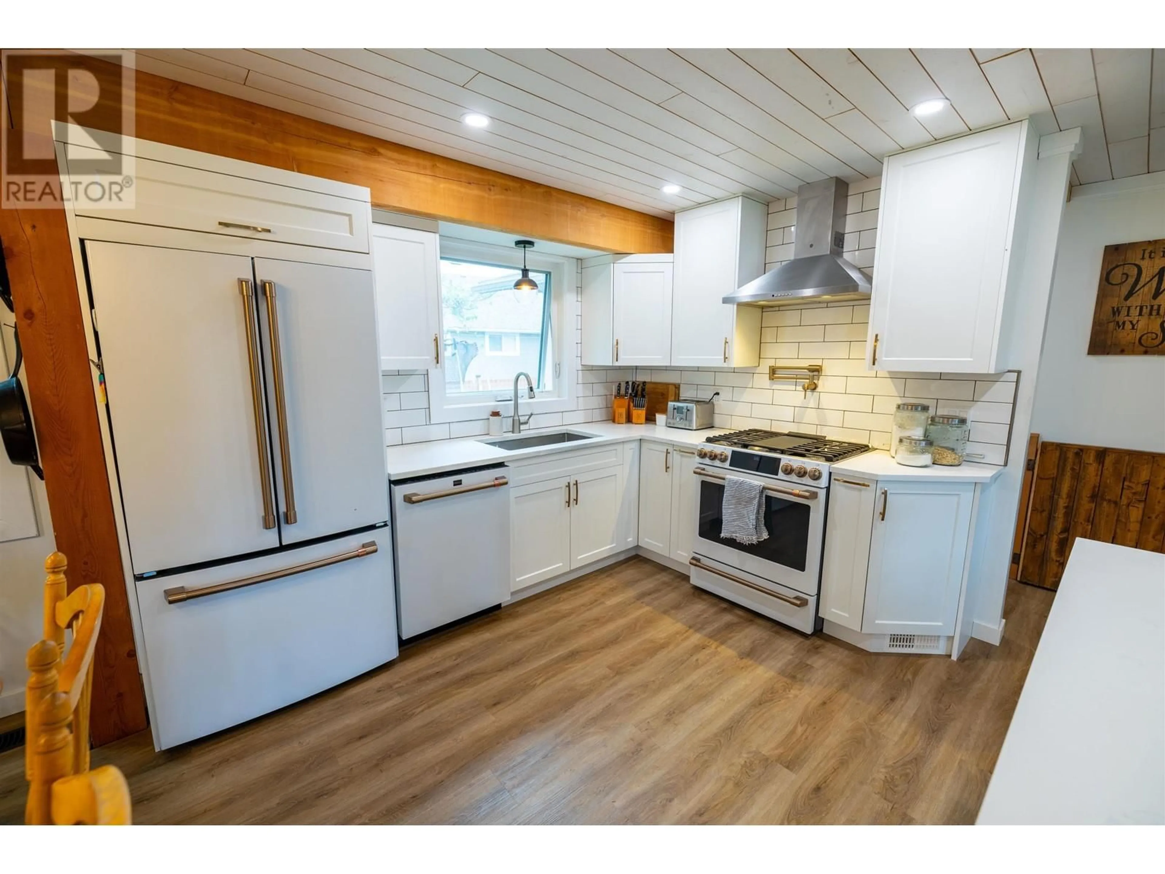 Open concept kitchen, wood/laminate floor for 7720 LANCASTER CRESCENT, Prince George British Columbia V2N3R5