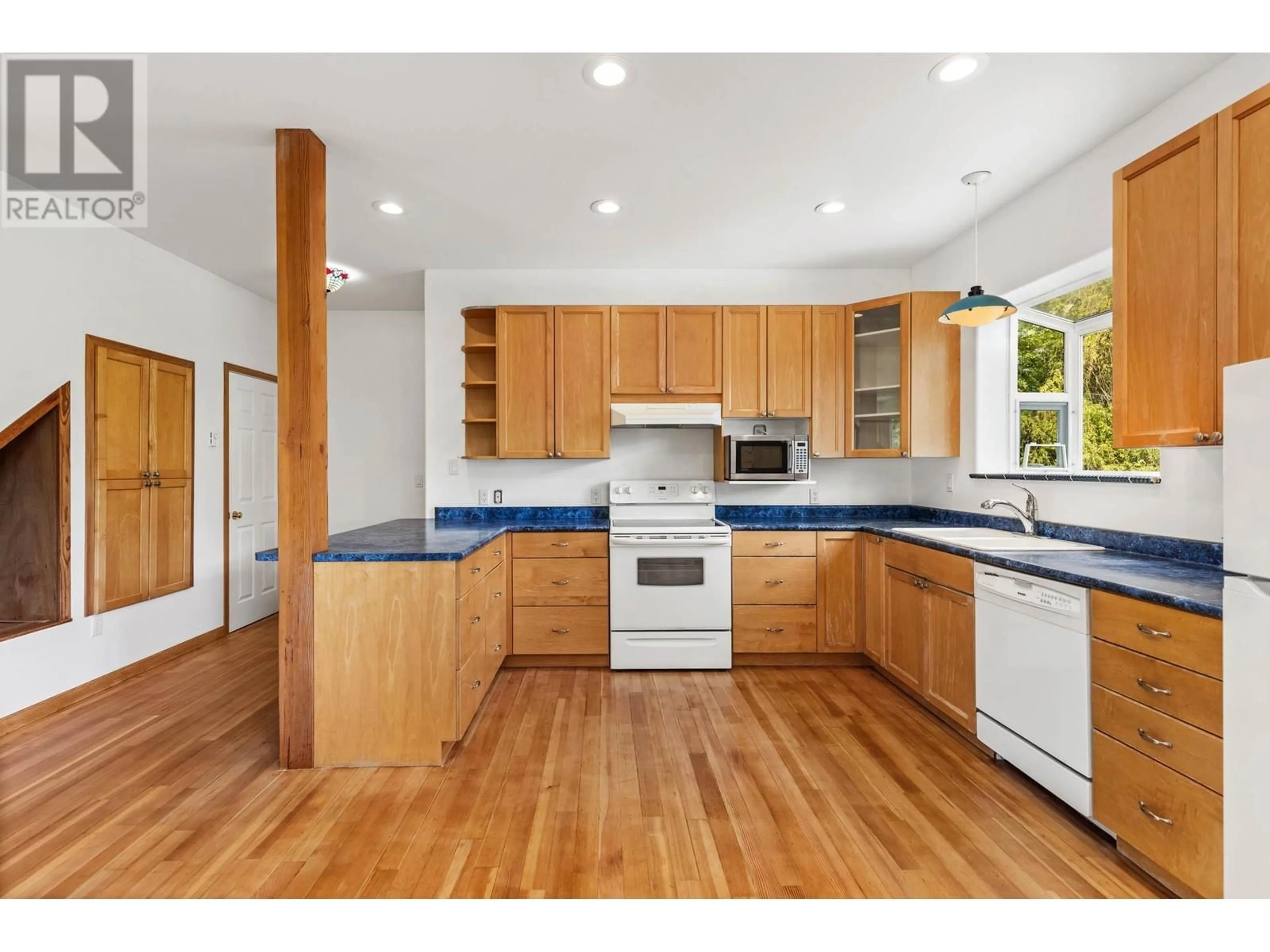 Open concept kitchen, wood/laminate floor for 1737 REID ROAD, Pemberton British Columbia V0N2K0
