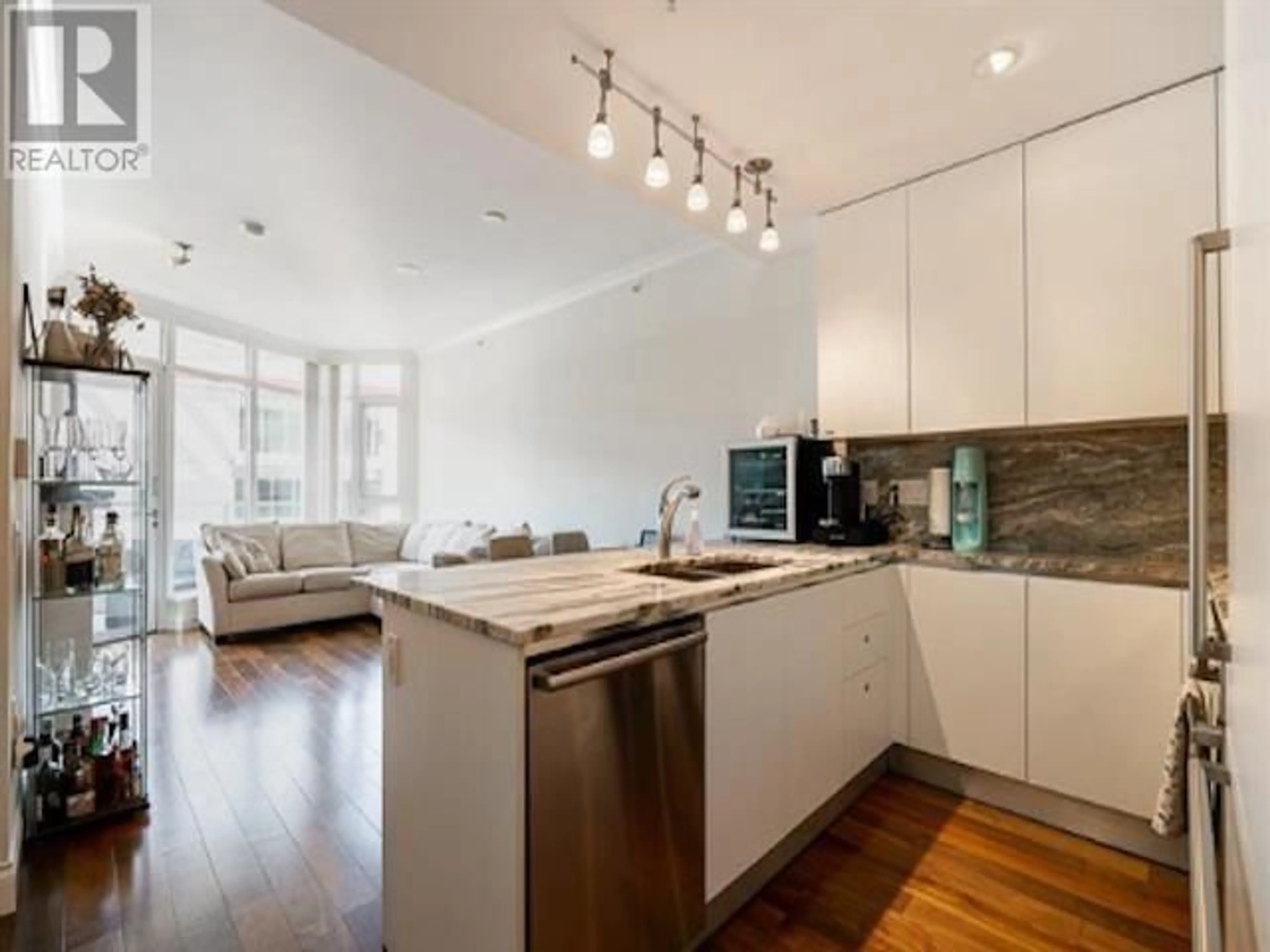 Open concept kitchen, wood/laminate floor for 806 - 199 VICTORY SHIP WAY, North Vancouver British Columbia V7L0E2