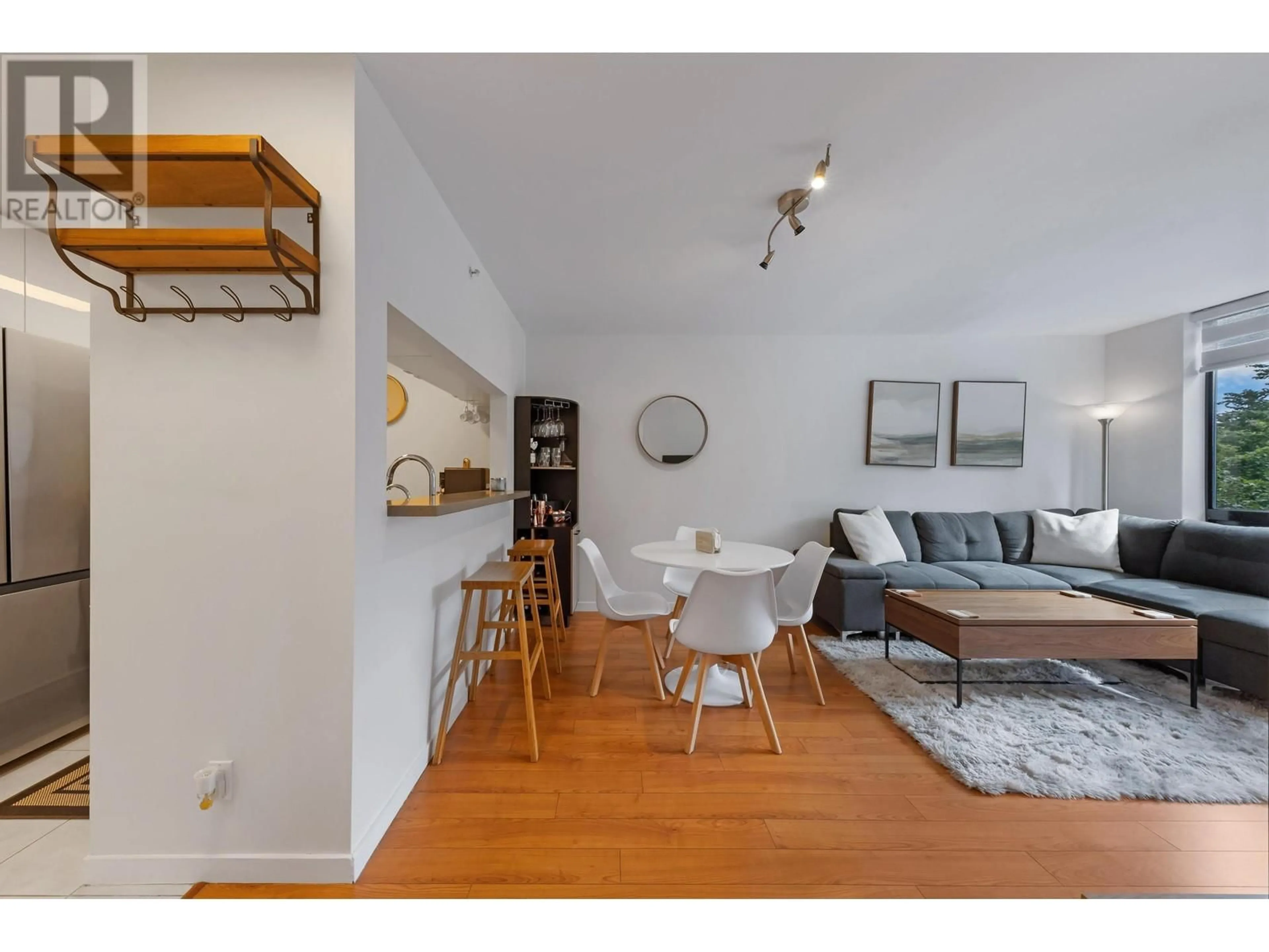 Living room with furniture, wood/laminate floor for 215 - 3663 CROWLEY DRIVE, Vancouver British Columbia V5R6H4