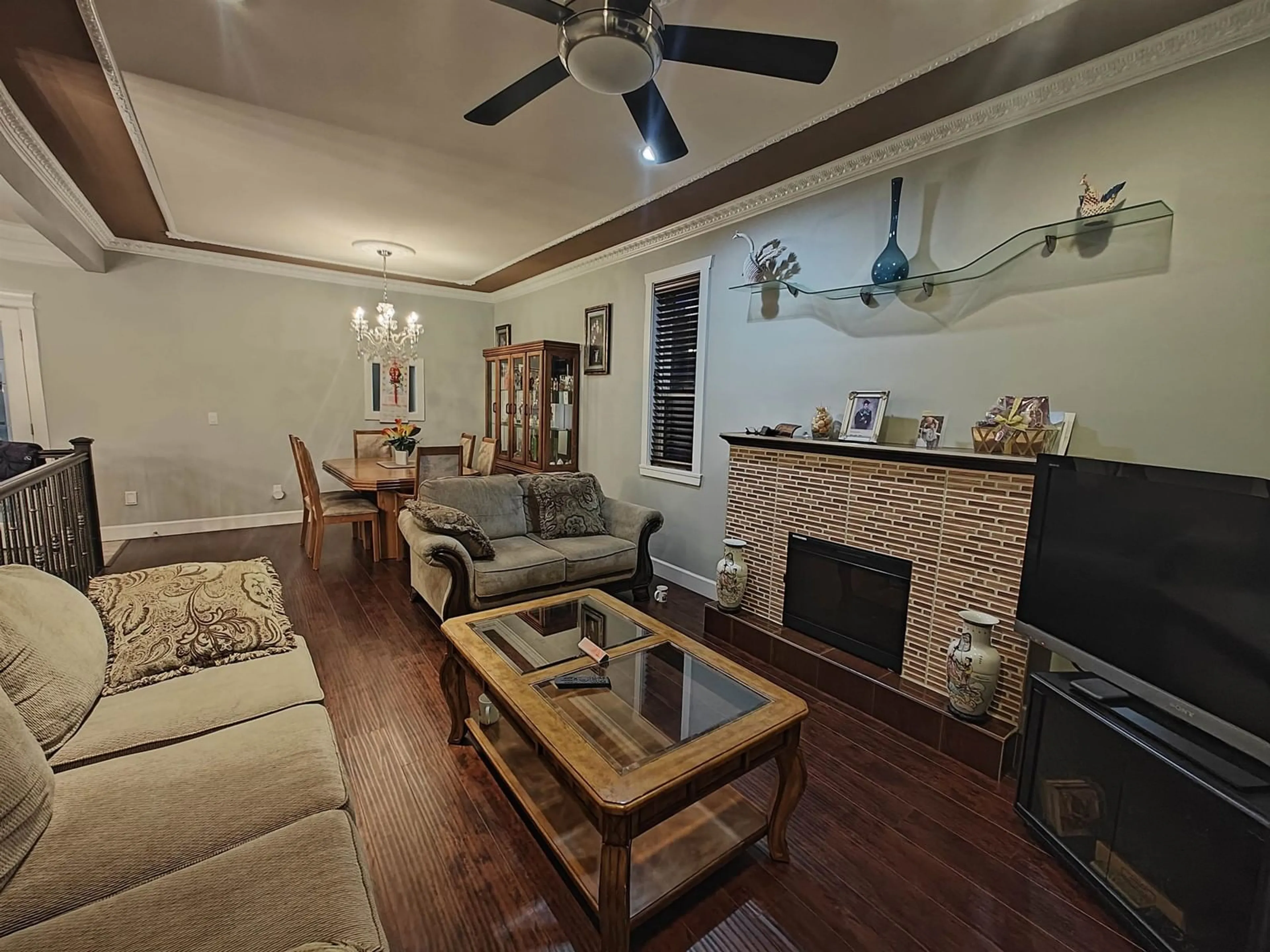 Living room with furniture, wood/laminate floor for 12854 107A, Surrey British Columbia V3T2G5
