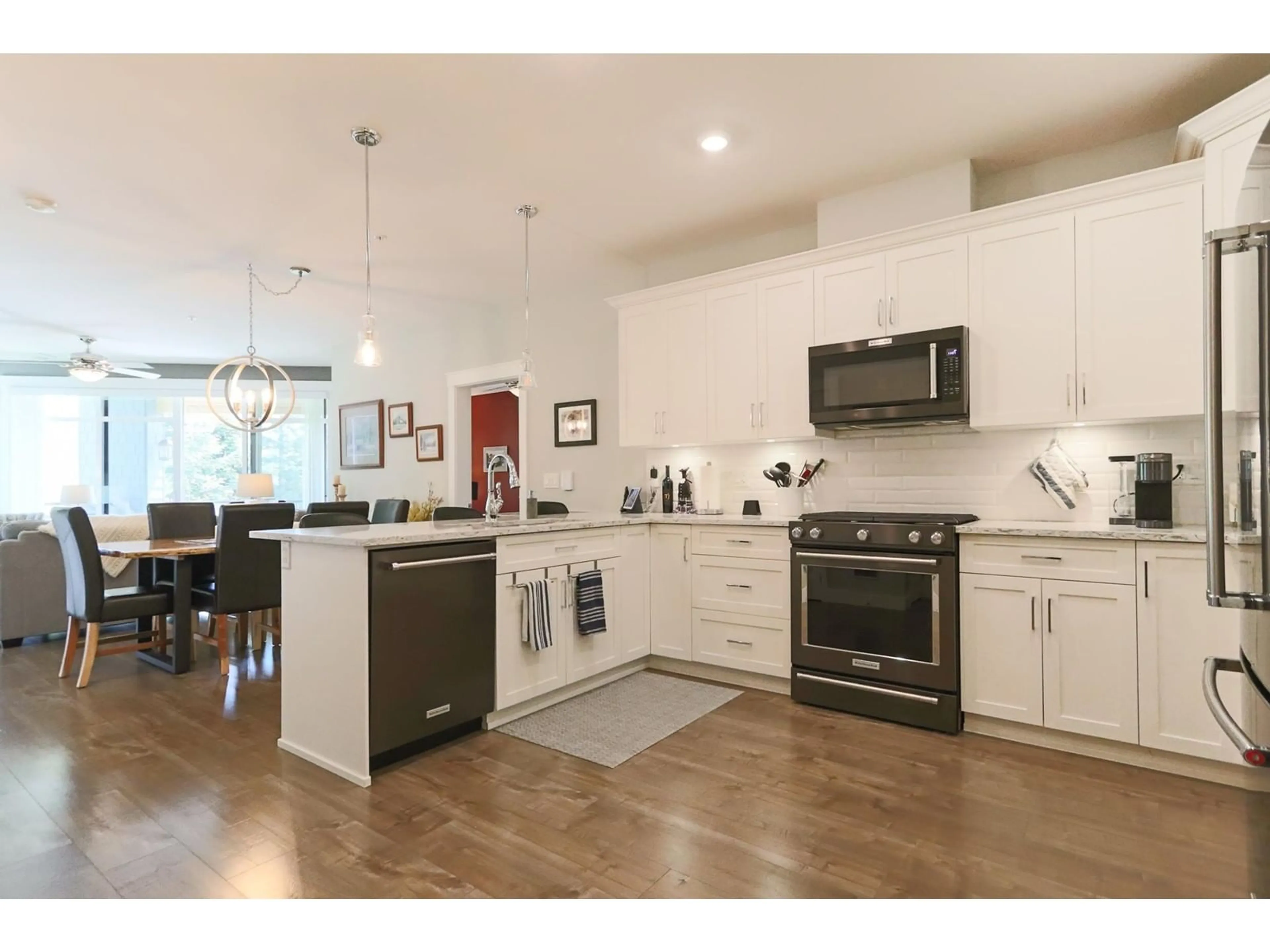 Open concept kitchen, wood/laminate floor for 207 - 5380 TYEE LANE, Chilliwack British Columbia V2R6B6