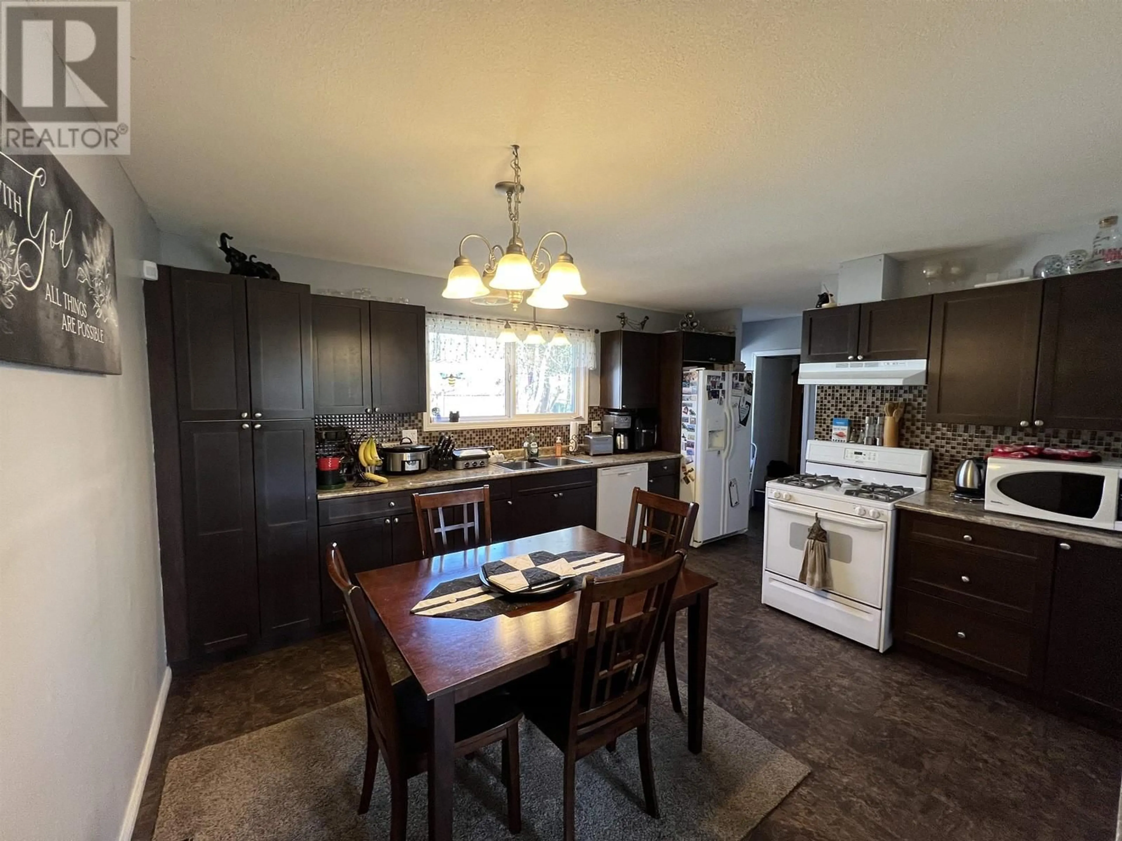 Open concept kitchen, wood/laminate floor for 5435 AIRPORT DRIVE, Fort Nelson British Columbia V0C1R0