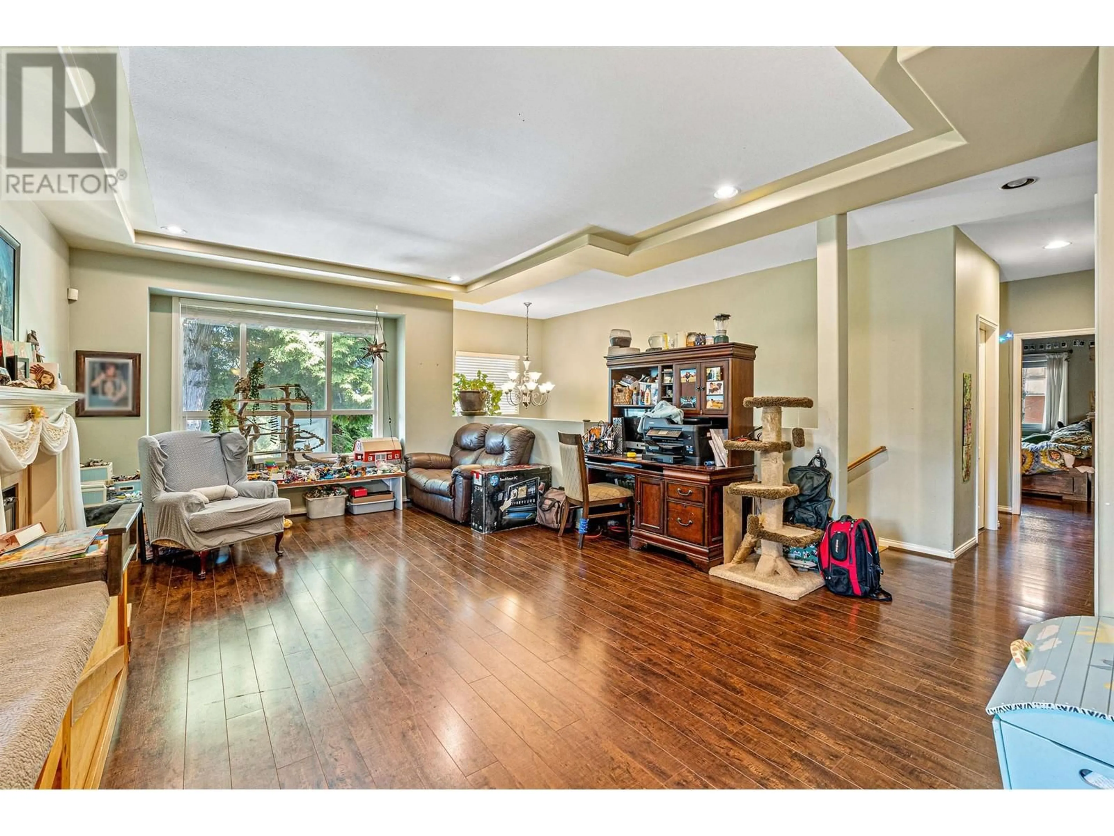 Living room with furniture, wood/laminate floor for 6693 CANADA WAY, Burnaby British Columbia V5E3P9
