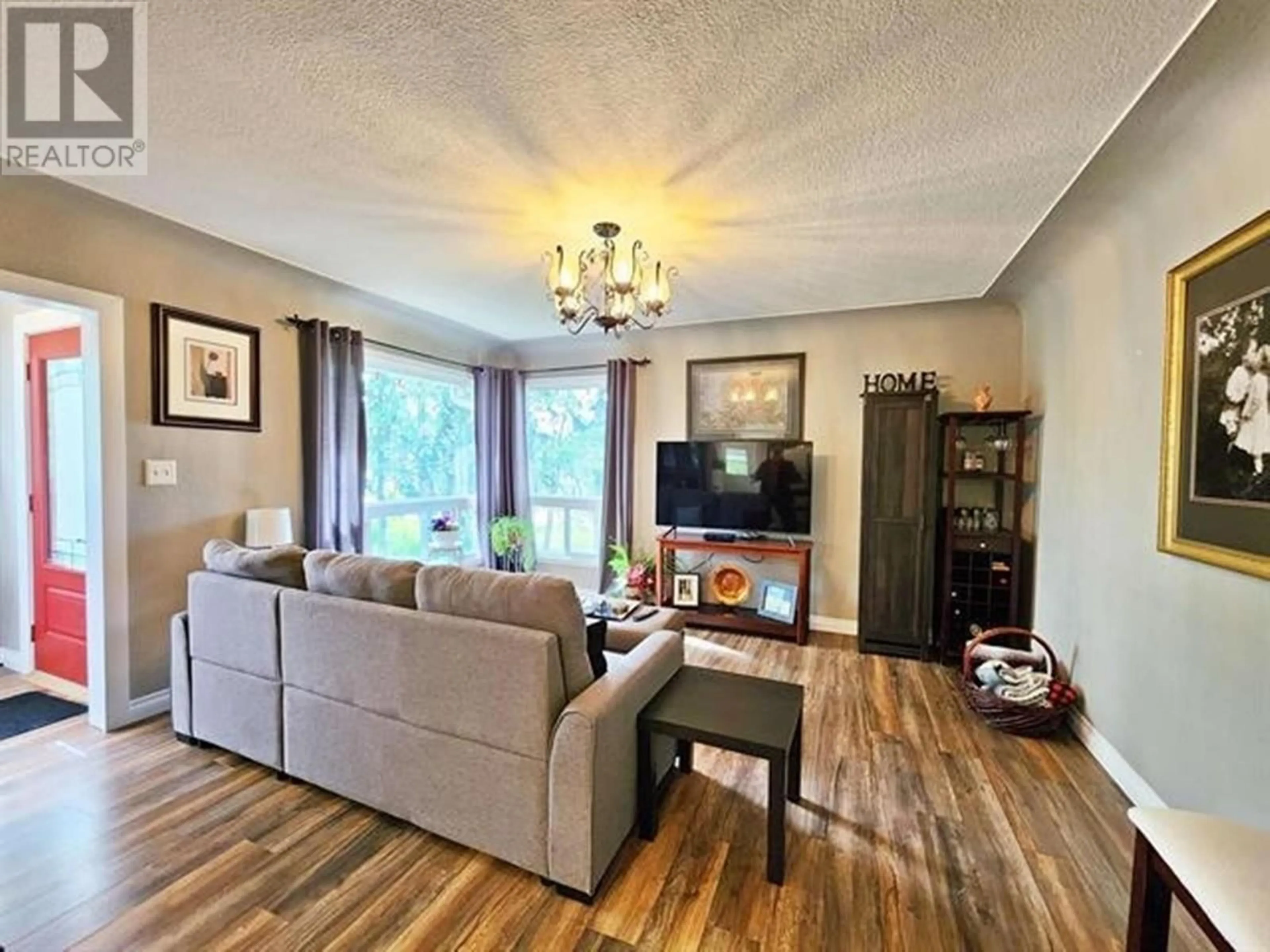 Living room with furniture, wood/laminate floor for 2290 ASH AVENUE, Quesnel British Columbia V2J3X7