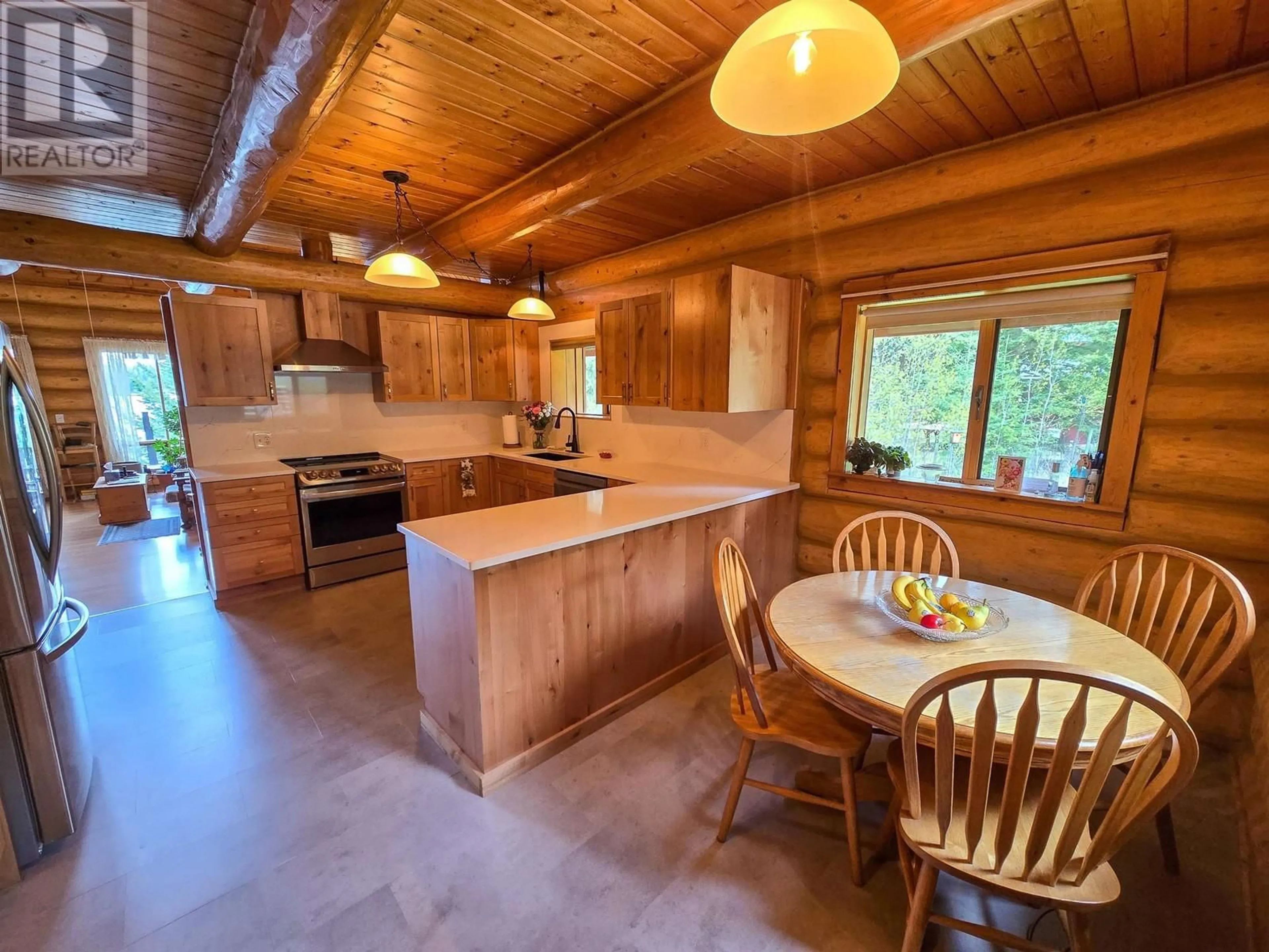 Open concept kitchen, wood/laminate floor for 7145 LINCOLN DRIVE, Sheridan Lake British Columbia V0K1X1