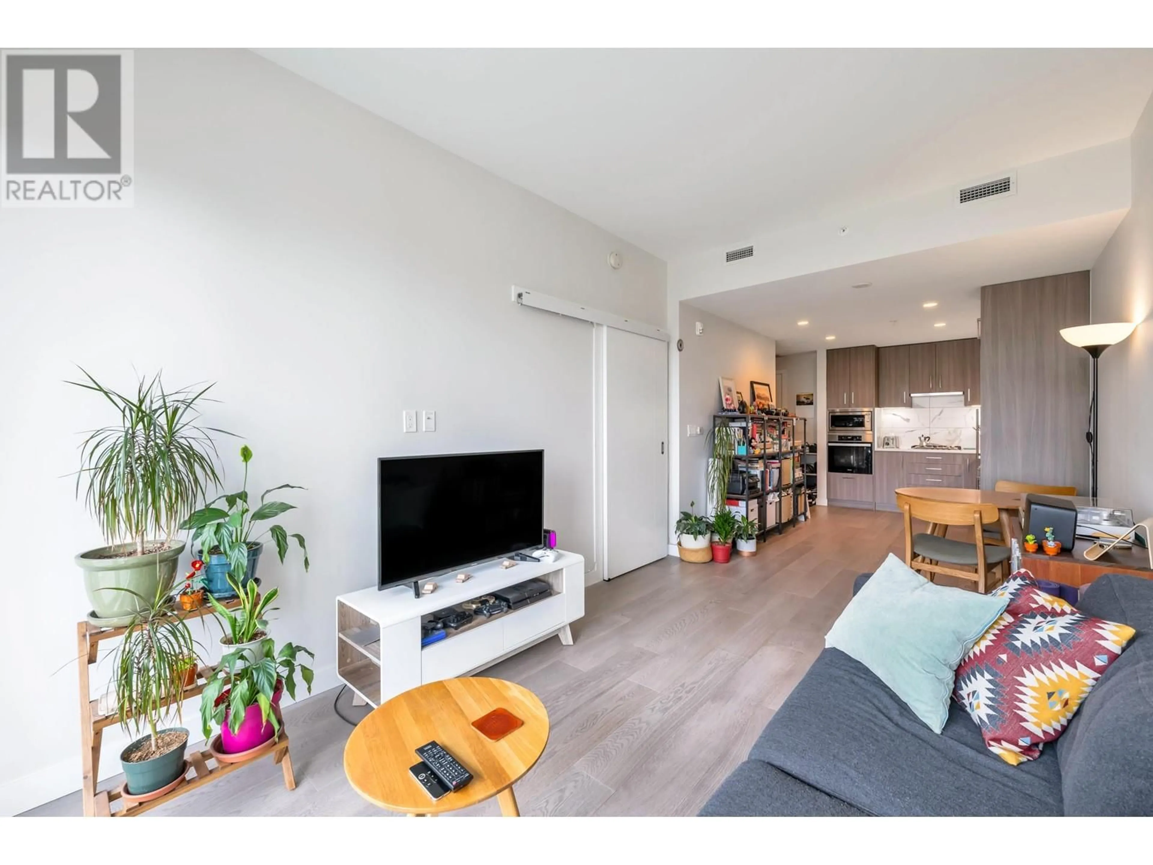 Living room with furniture, wood/laminate floor for 209 - 528 KING EDWARD AVENUE, Vancouver British Columbia V5Z2C3
