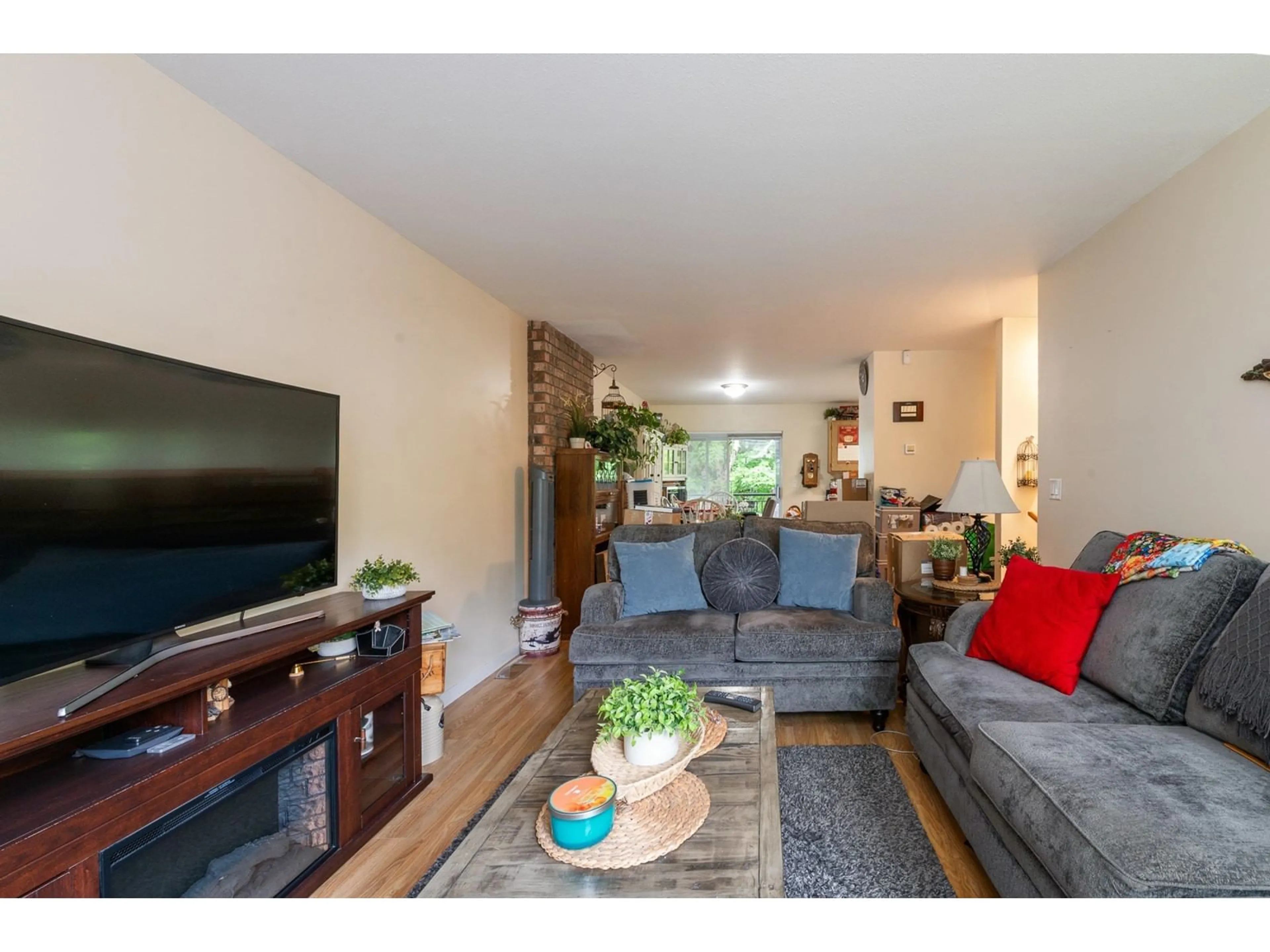 Living room with furniture, wood/laminate floor for 6015 195A, Surrey British Columbia V3S7K9