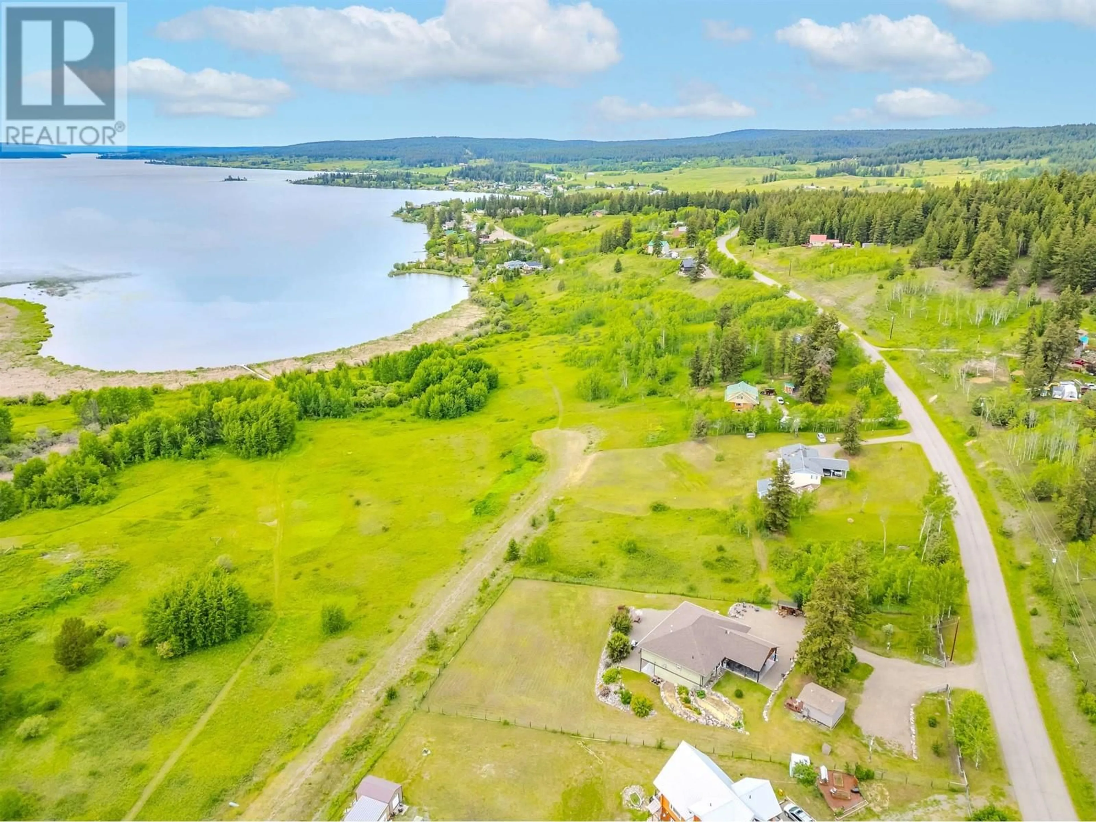 A pic from outside/outdoor area/front of a property/back of a property/a pic from drone, water/lake/river/ocean view for 4162 LAC LA HACHE STATION ROAD, 100 Mile House British Columbia V0K1T0