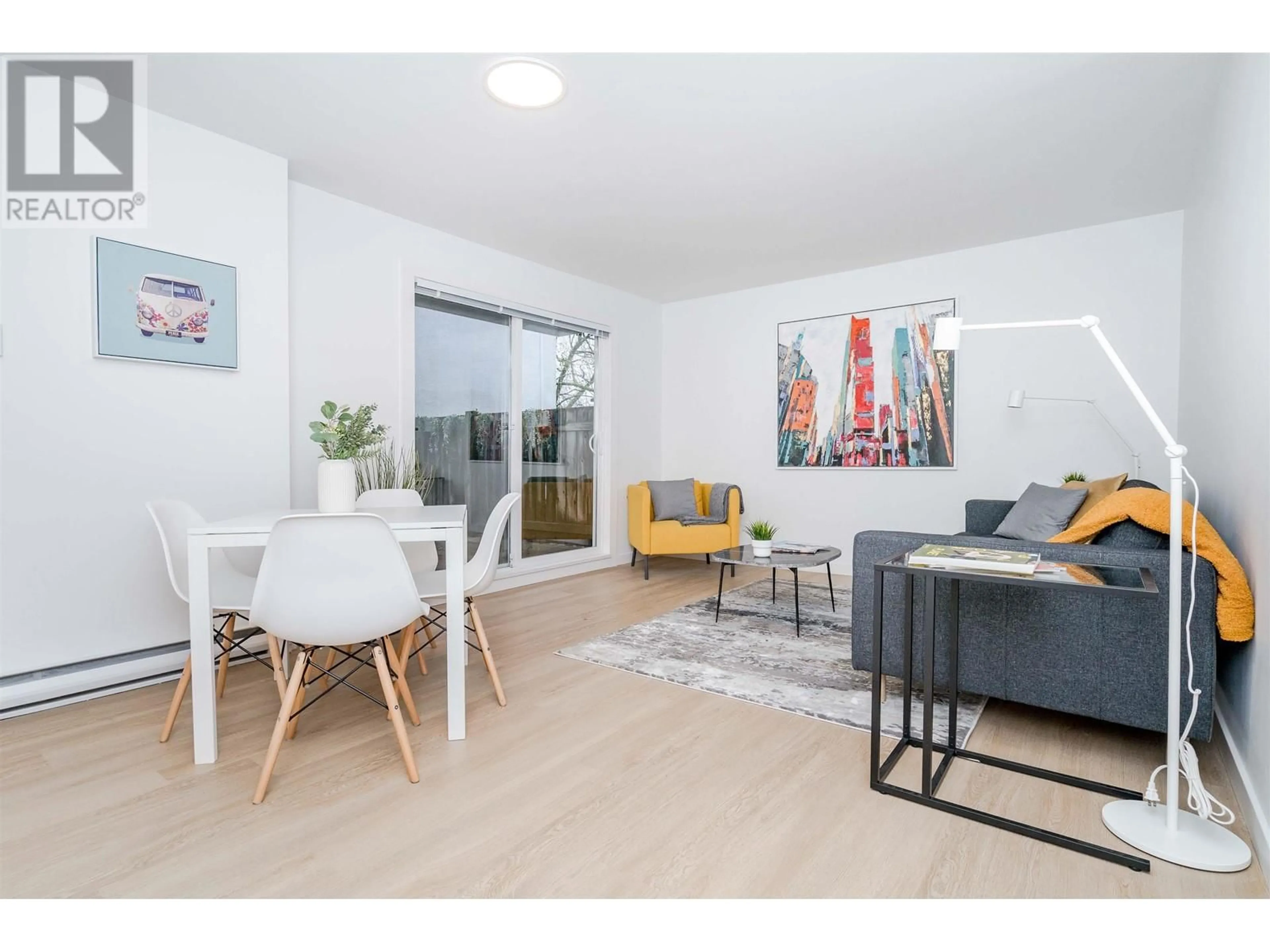 Living room with furniture, wood/laminate floor for 102 - 8690 MONTCALM STREET, Vancouver British Columbia V6P4P8