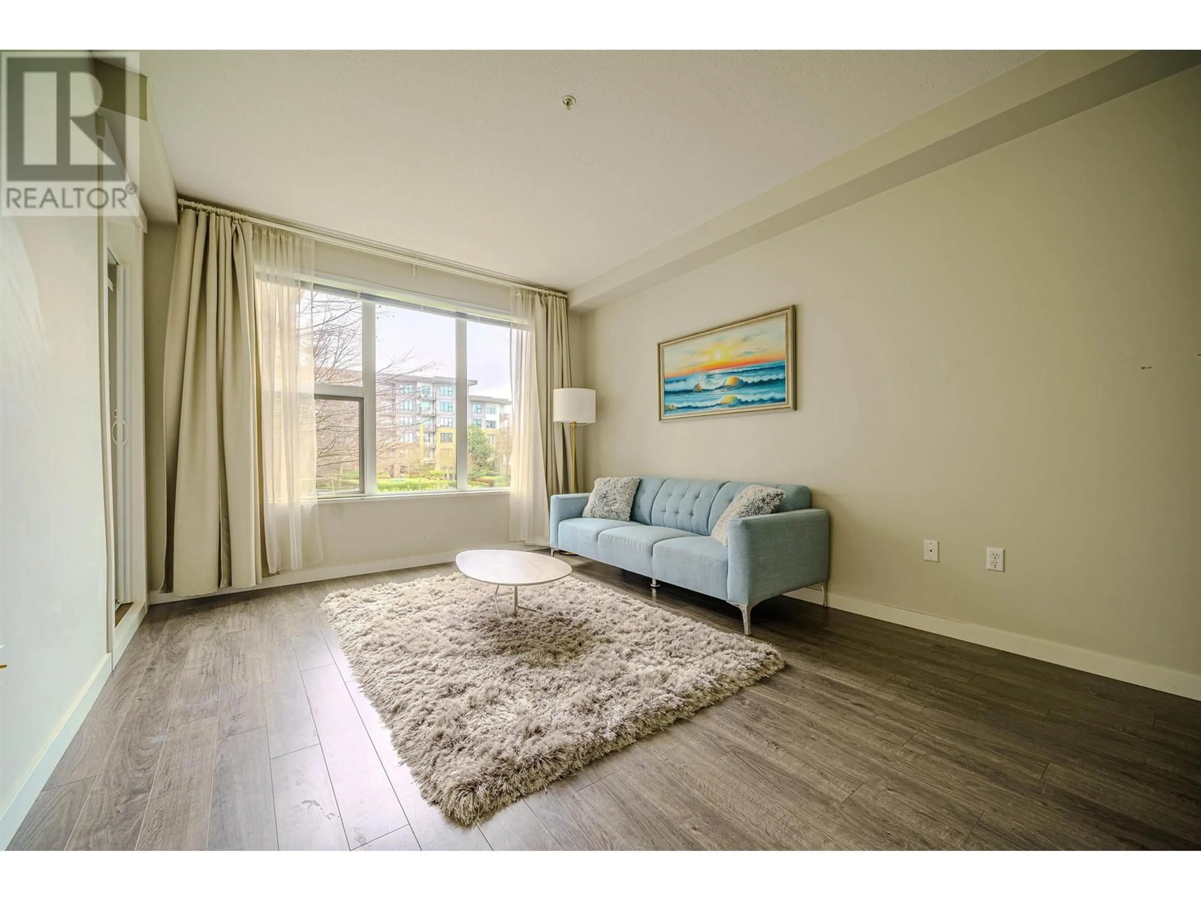 Living room with furniture, wood/laminate floor for 209 - 9311 ALEXANDRA ROAD, Richmond British Columbia V6X2K5