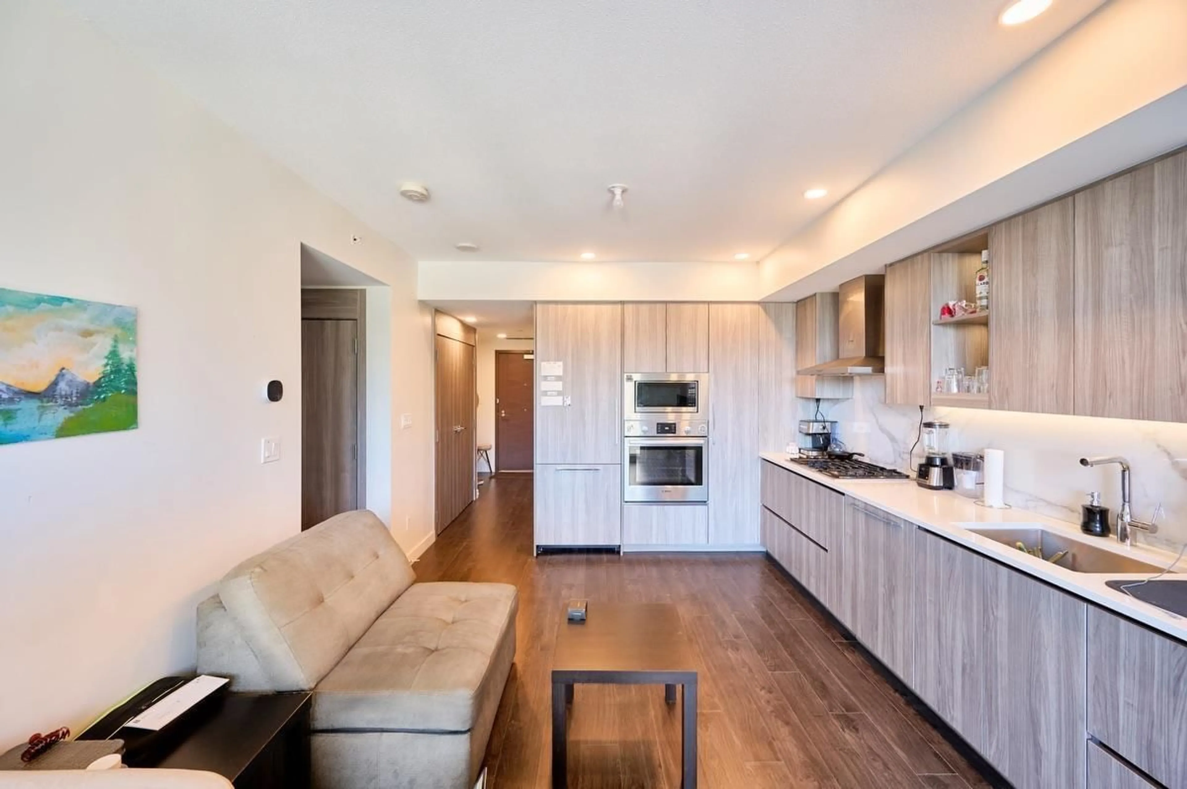 Open concept kitchen, wood/laminate floor for 308 - 9887 WHALLEY, Surrey British Columbia V3T0P4