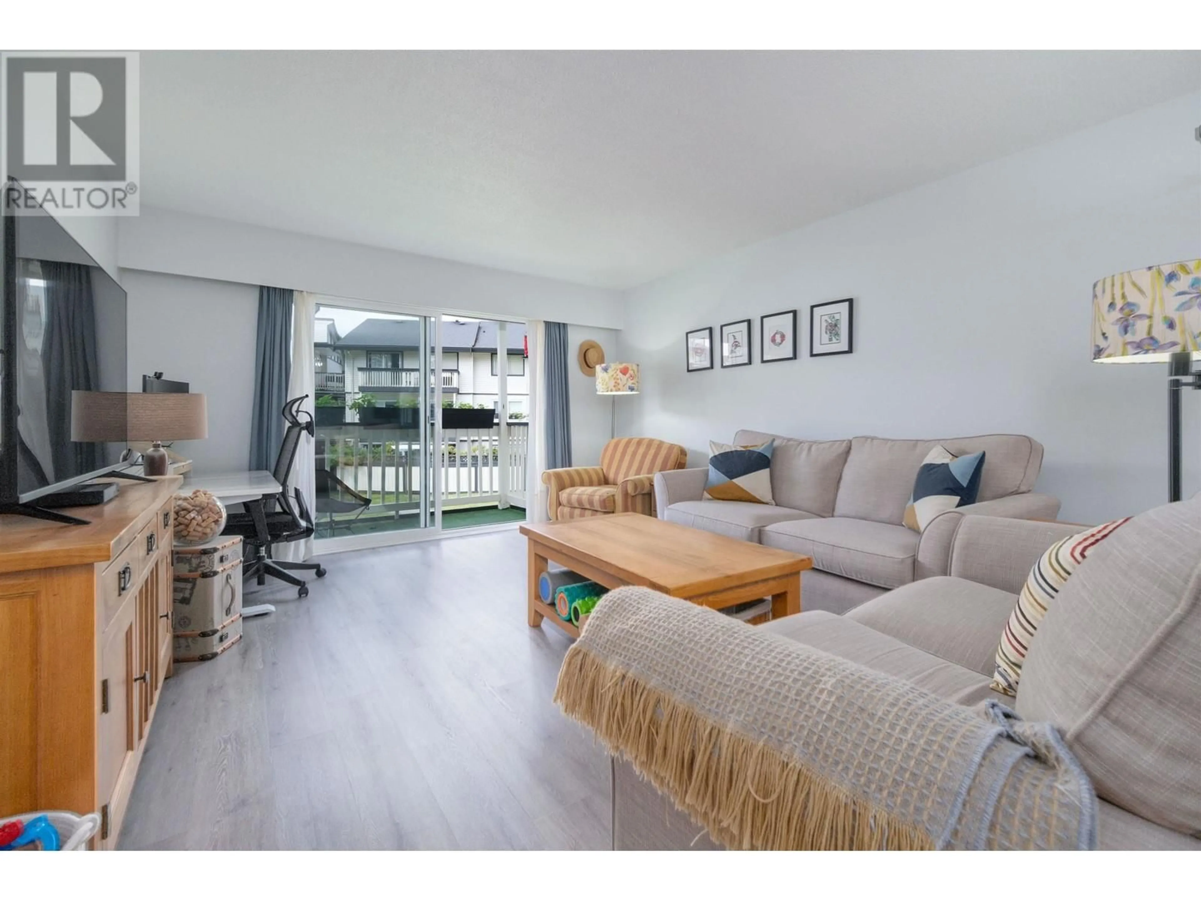 Living room with furniture, wood/laminate floor for 216 - 780 PREMIER STREET, North Vancouver British Columbia V7J2G8