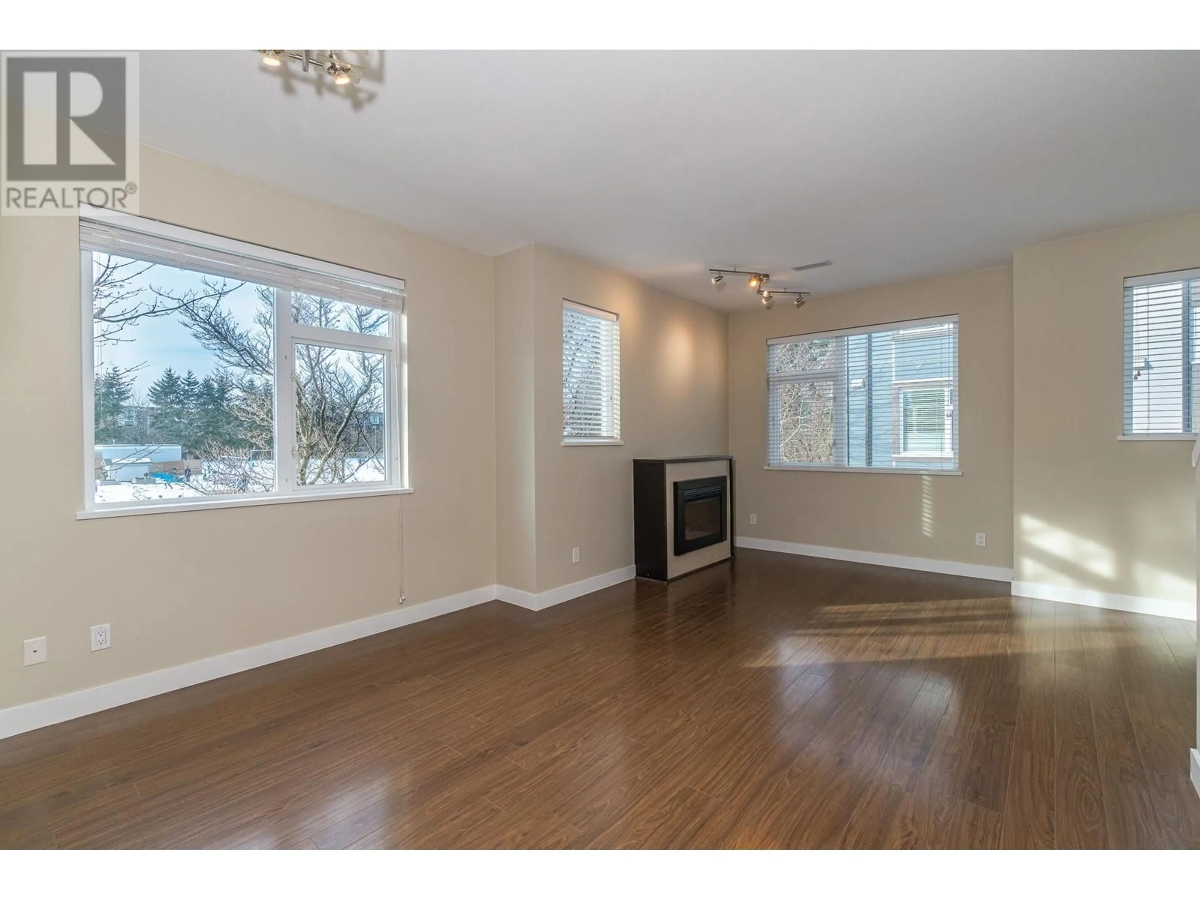 Living room with furniture, wood/laminate floor for 23 - 4099 NO. 4 ROAD, Richmond British Columbia V6X2M2