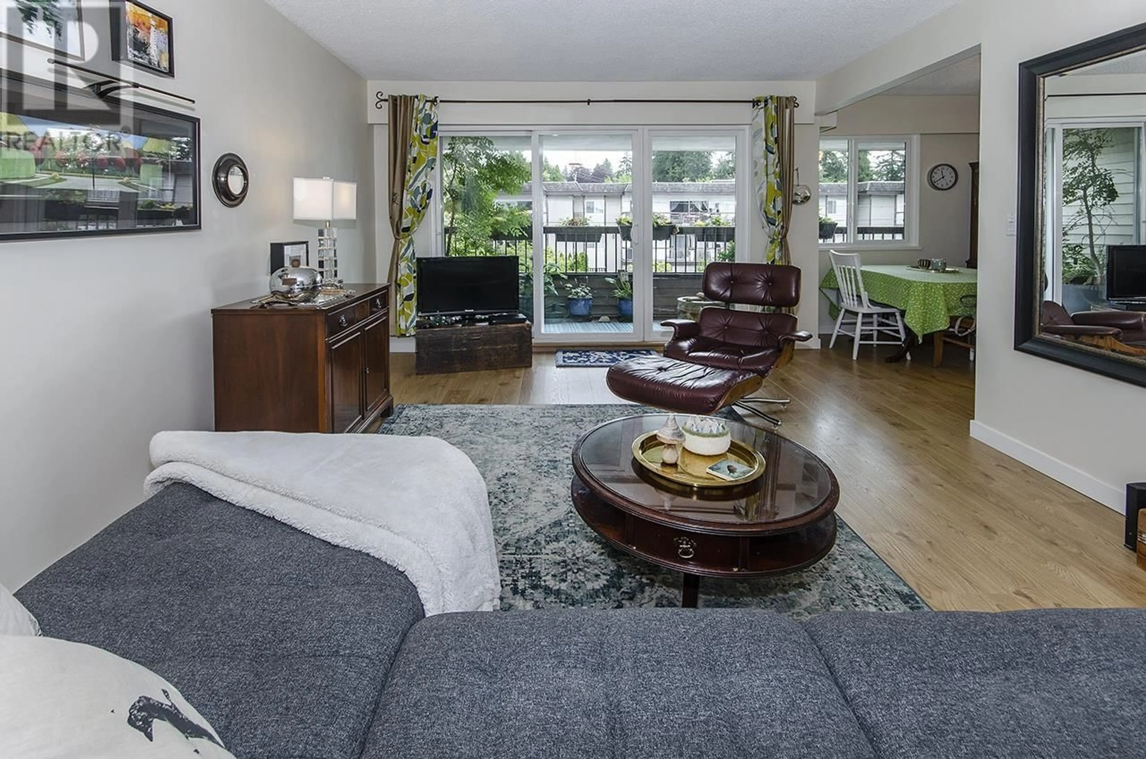 Living room with furniture, wood/laminate floor for 202 - 105 KINGS ROAD, North Vancouver British Columbia V7N2L7