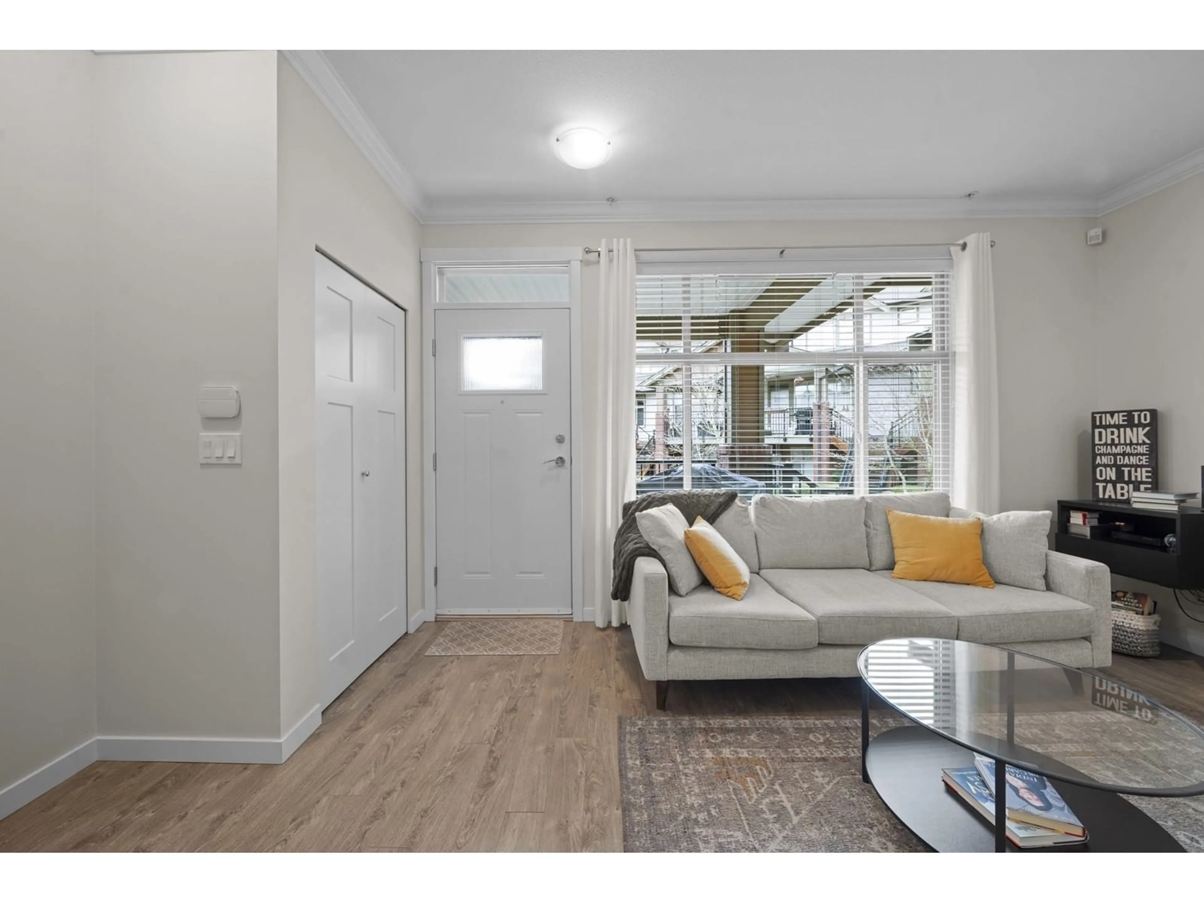 Living room with furniture, wood/laminate floor for 208 - 6655 192, Surrey British Columbia V4N0B9