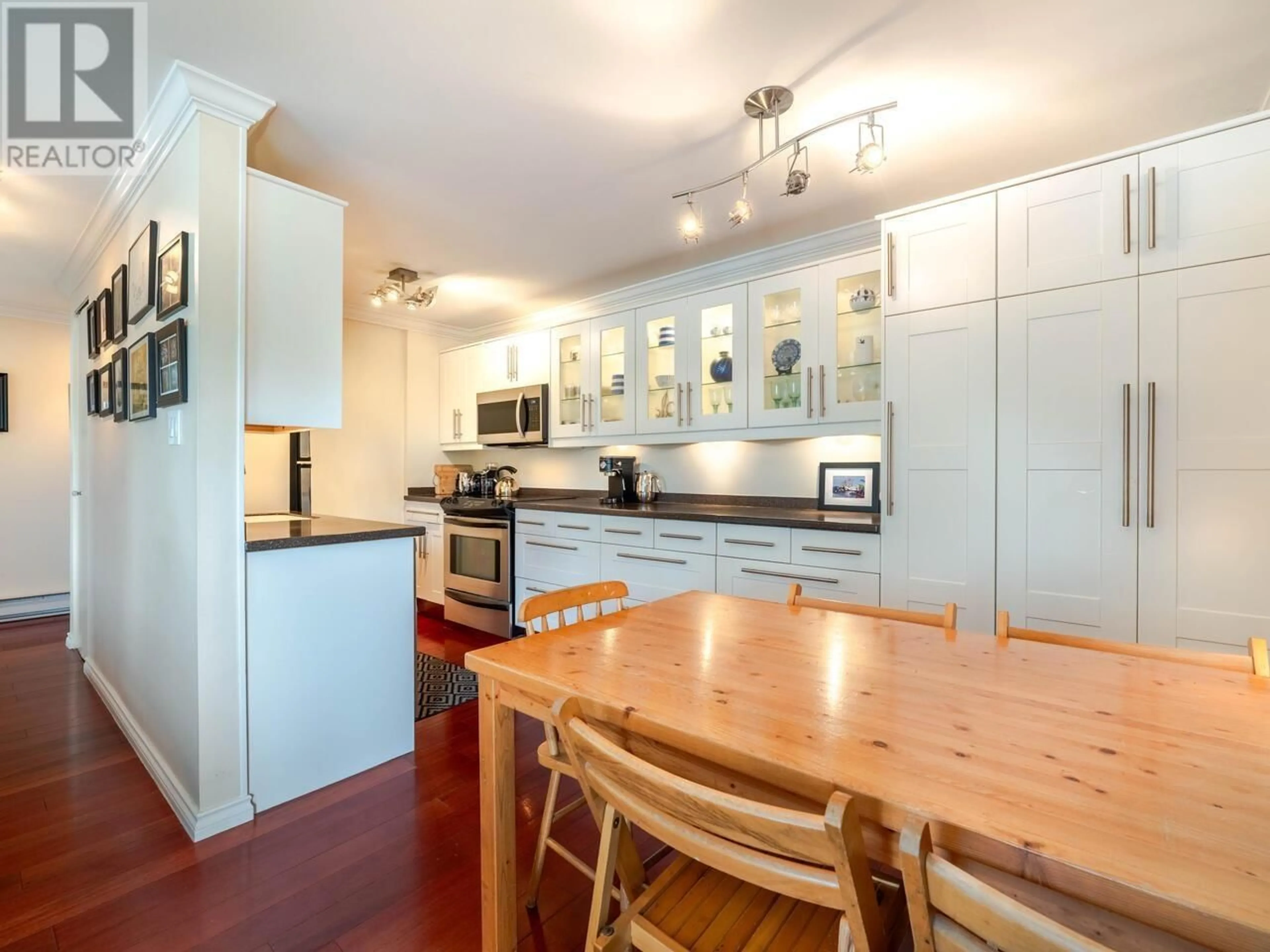 Open concept kitchen, wood/laminate floor for 204 - 777 7TH AVENUE, Vancouver British Columbia V5Z1B9