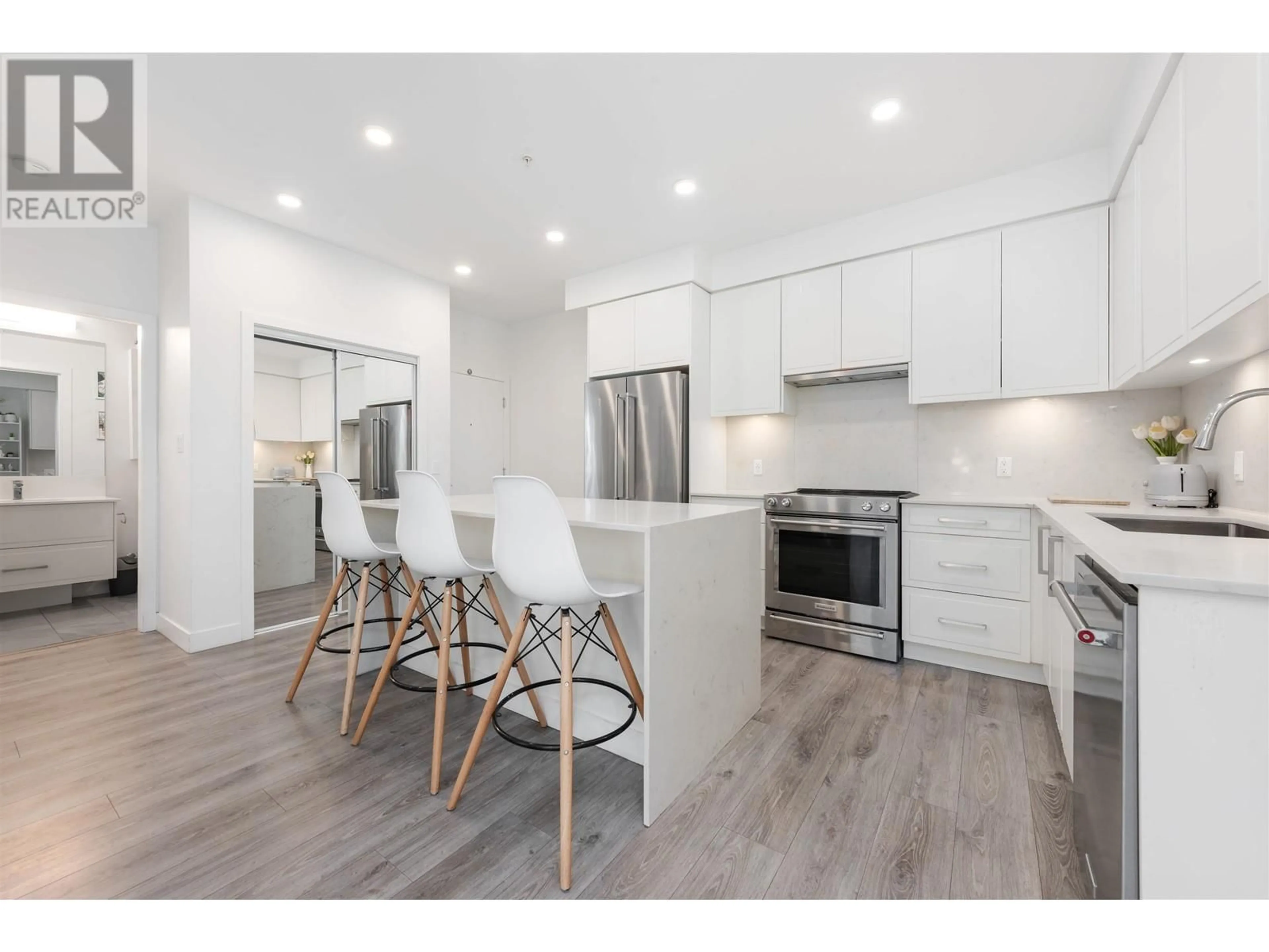 Open concept kitchen, wood/laminate floor for 313 - 700 CLARKE ROAD, Coquitlam British Columbia V3J0K5