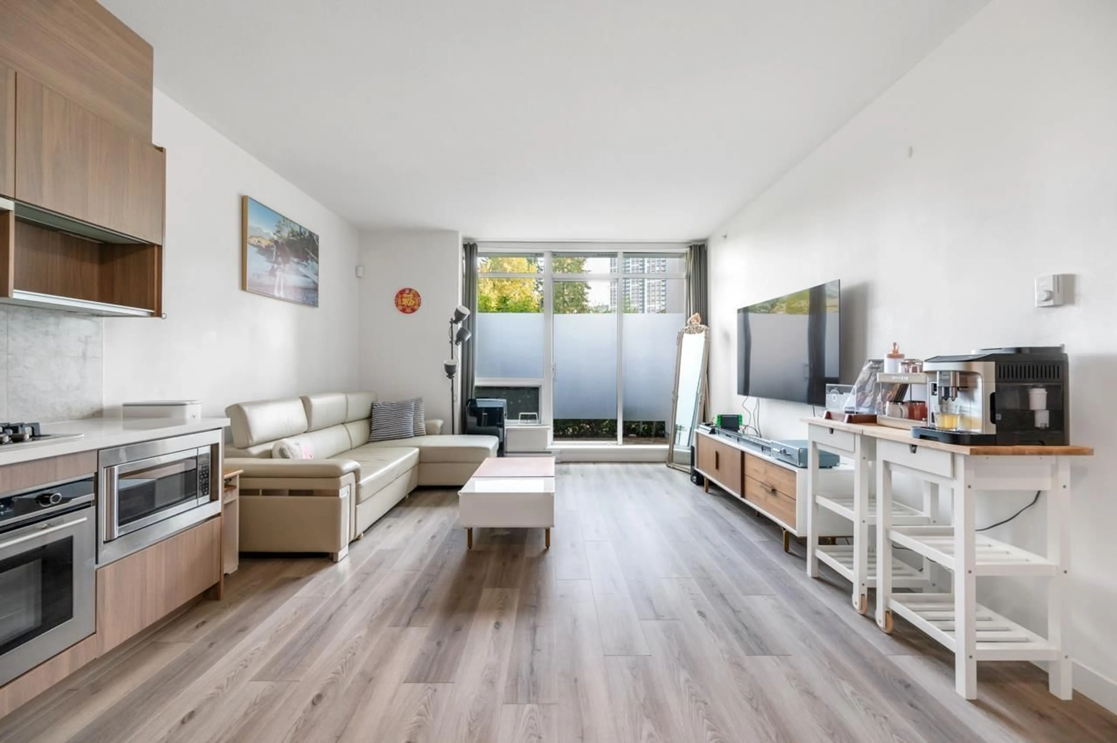 Living room with furniture, wood/laminate floor for 201 - 13750 100, Surrey British Columbia V3T0L3