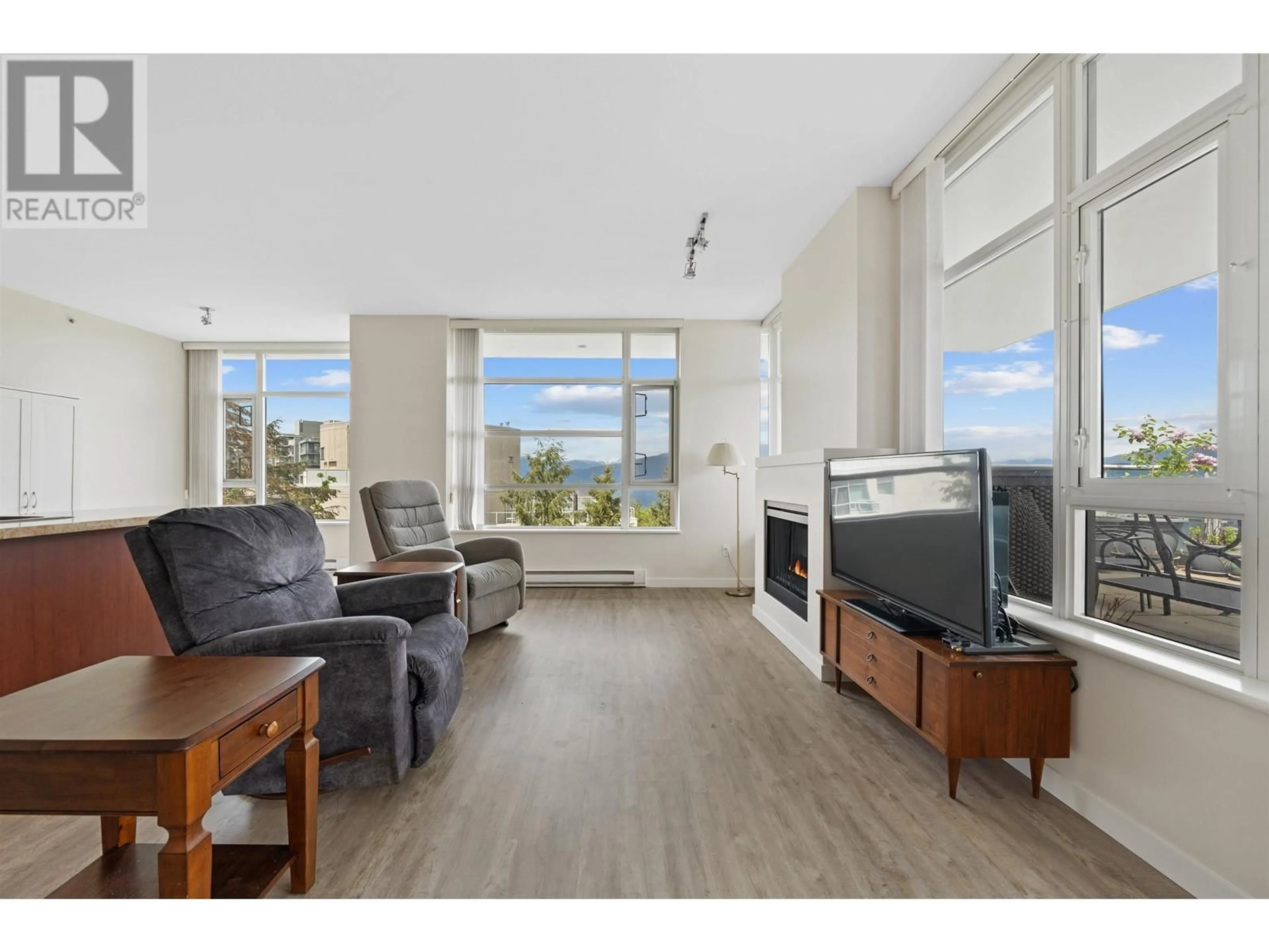 Living room with furniture, wood/laminate floor for 1206 - 9266 UNIVERSITY CRESCENT, Burnaby British Columbia V5A4Z1
