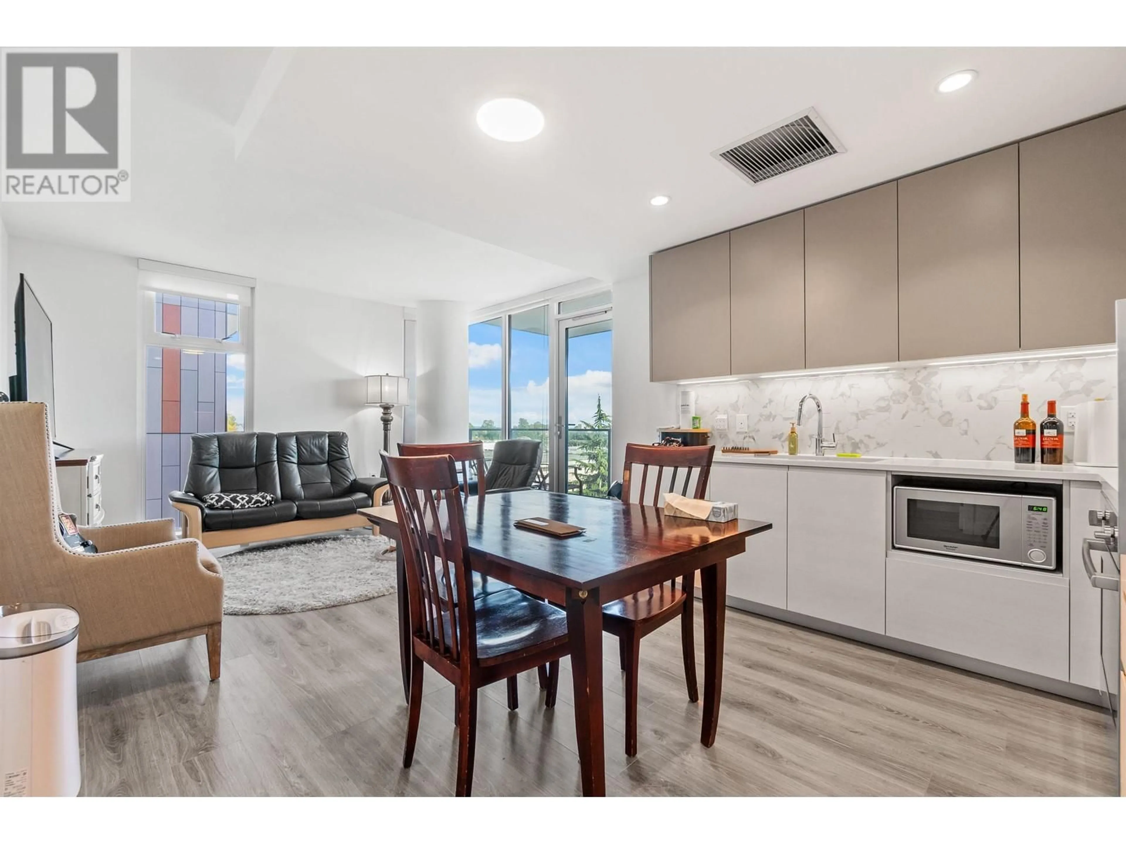 Open concept kitchen, wood/laminate floor for 502 - 8188 FRASER STREET, Vancouver British Columbia V5X0J8