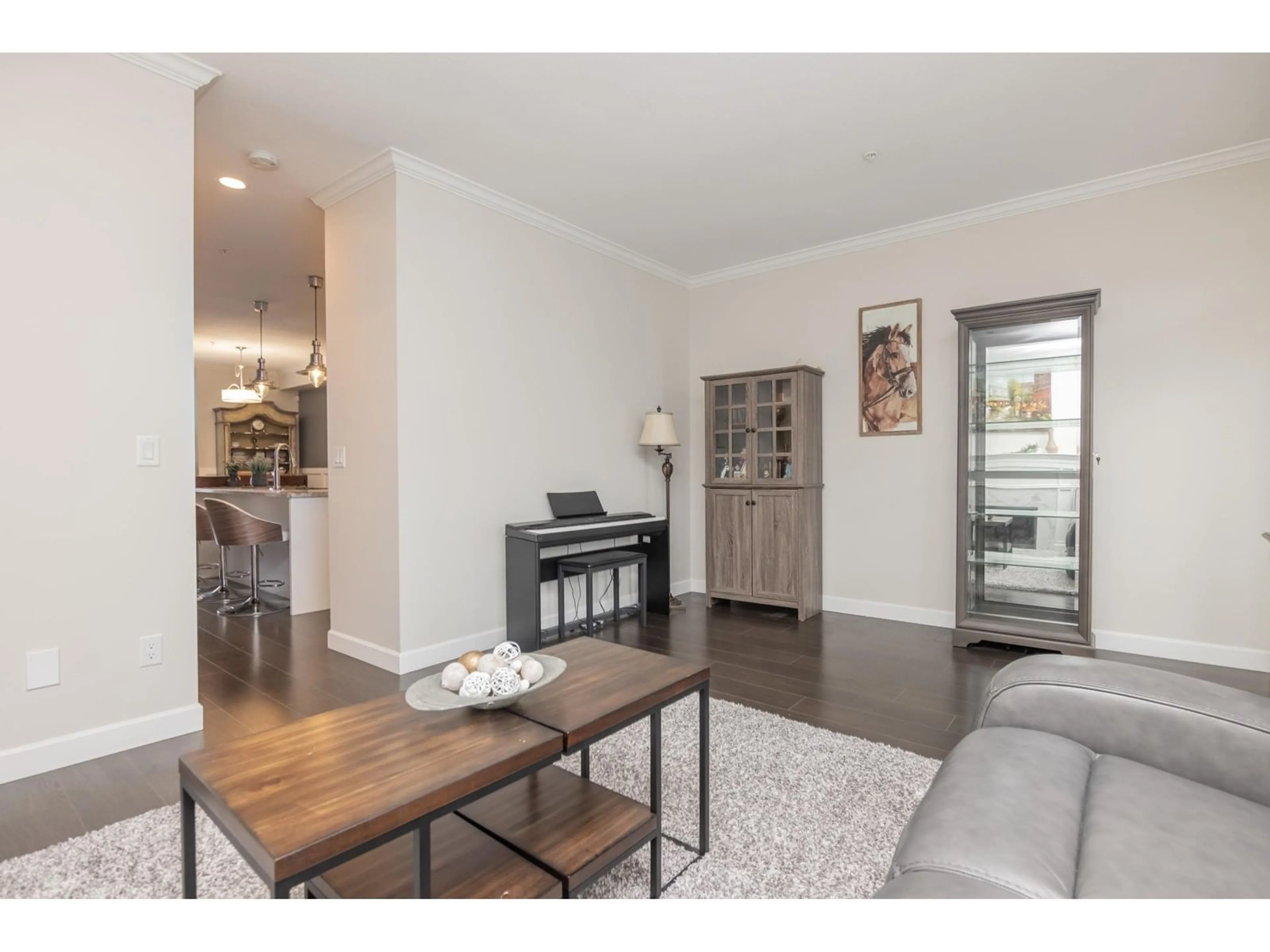 Living room with furniture, wood/laminate floor for 4 - 7157 210, Langley British Columbia V2Y0T3