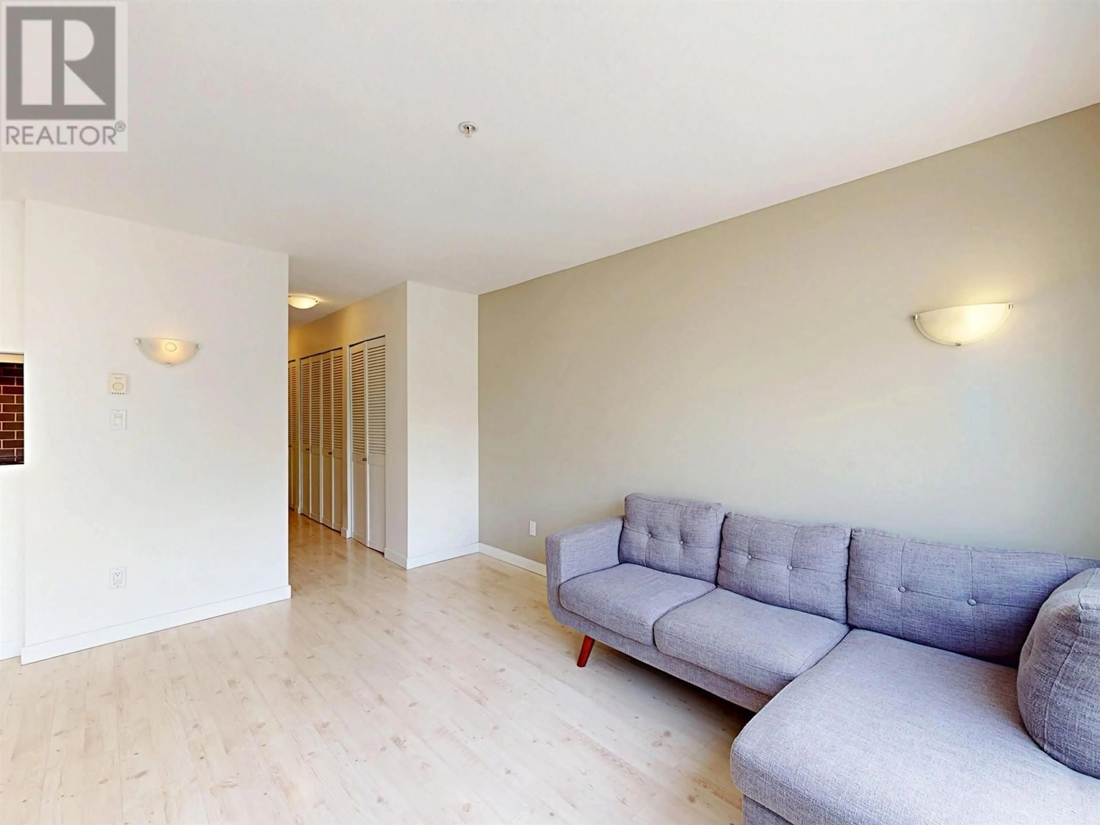 Living room with furniture, wood/laminate floor for 205 - 1554 BURNABY STREET, Vancouver British Columbia V6G1W9