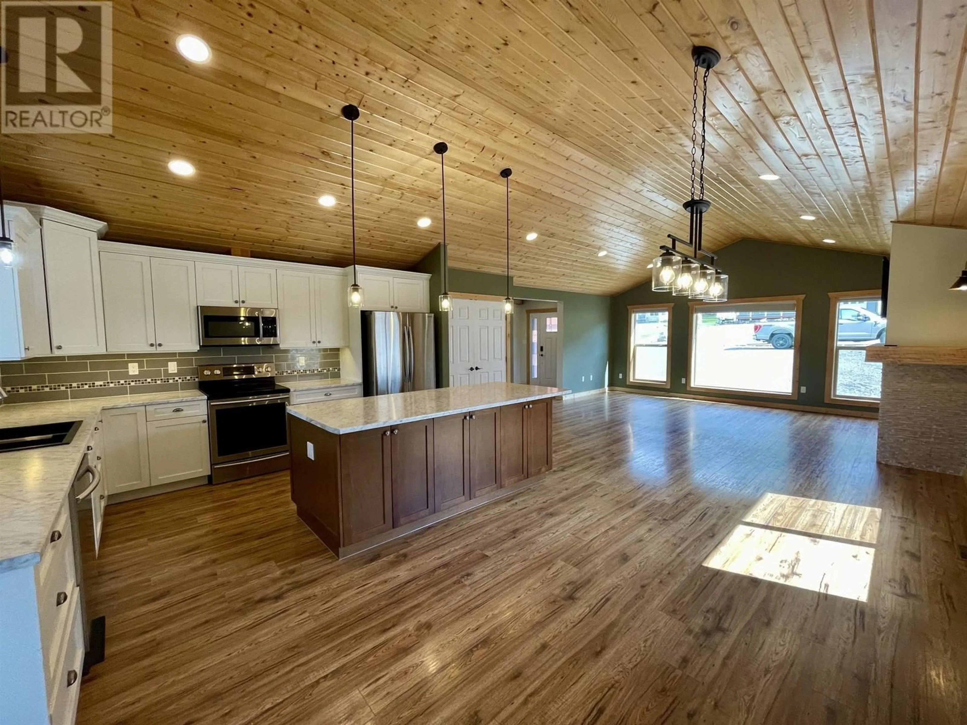 Open concept kitchen, wood/laminate floor for 315 BLACKSTOCK ROAD, 100 Mile House British Columbia V0K2E0