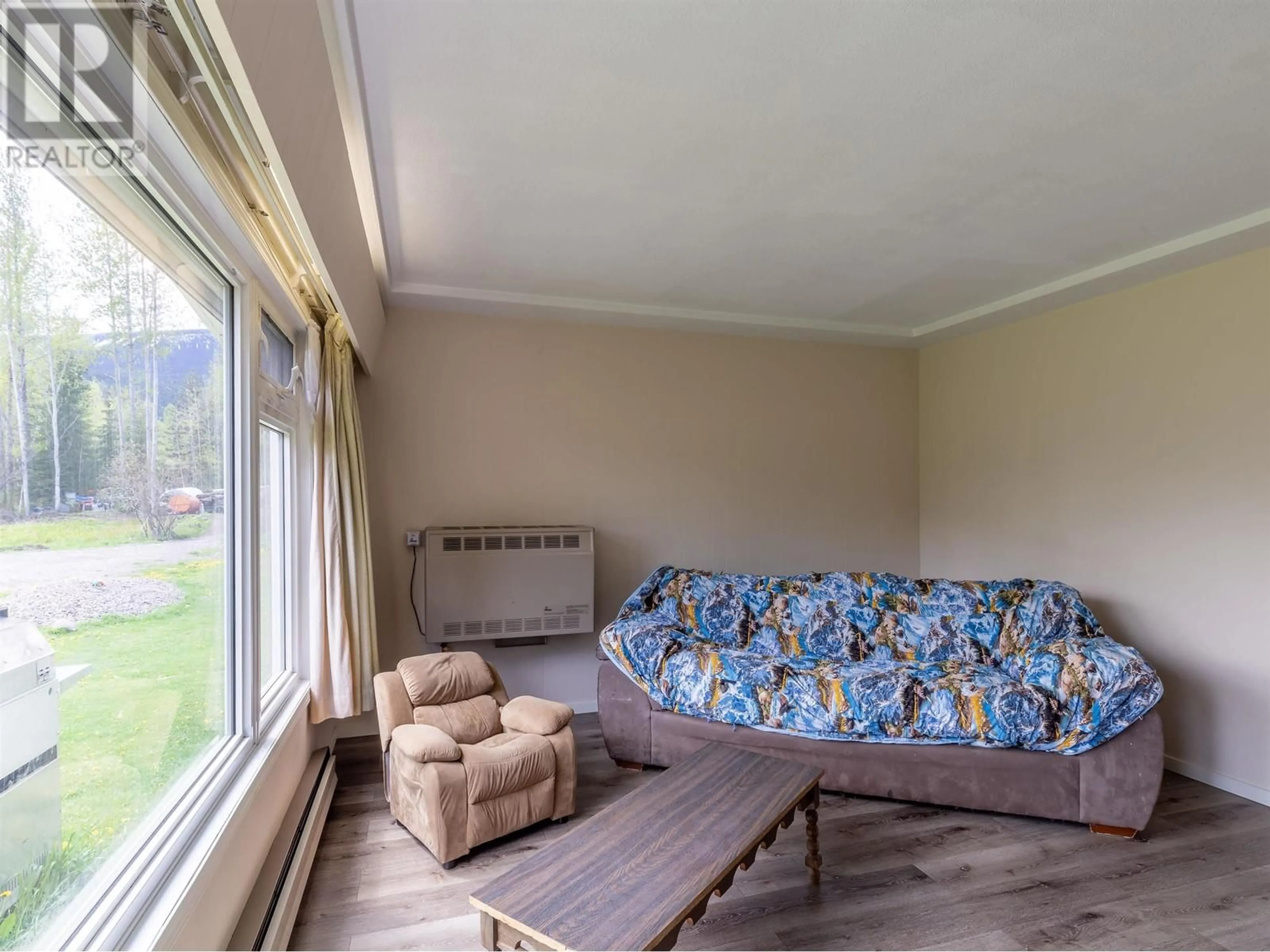 Living room with furniture, wood/laminate floor for 4365 LAKE KATHLYN ROAD, Smithers British Columbia V0J2N2