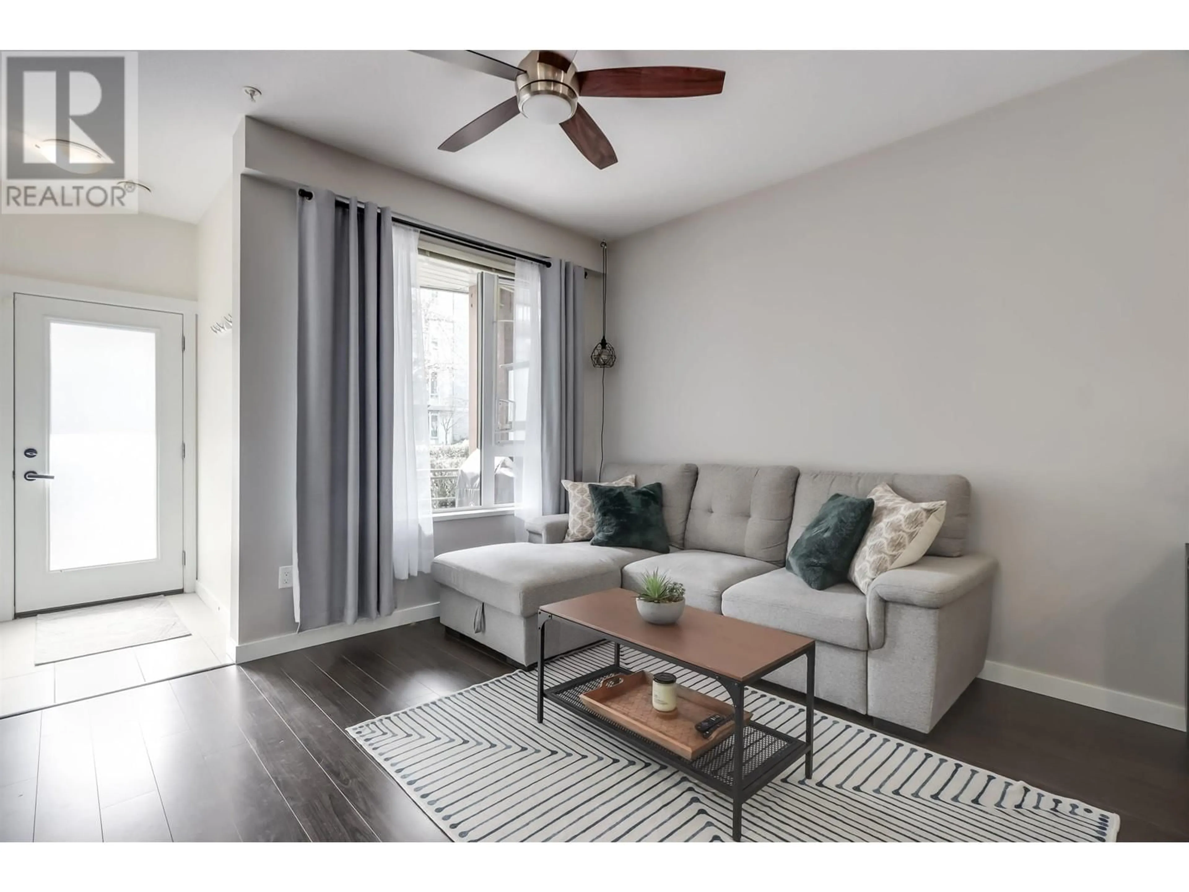 Living room with furniture, wood/laminate floor for 107 - 3163 RIVERWALK AVENUE, Vancouver British Columbia V5S0A8