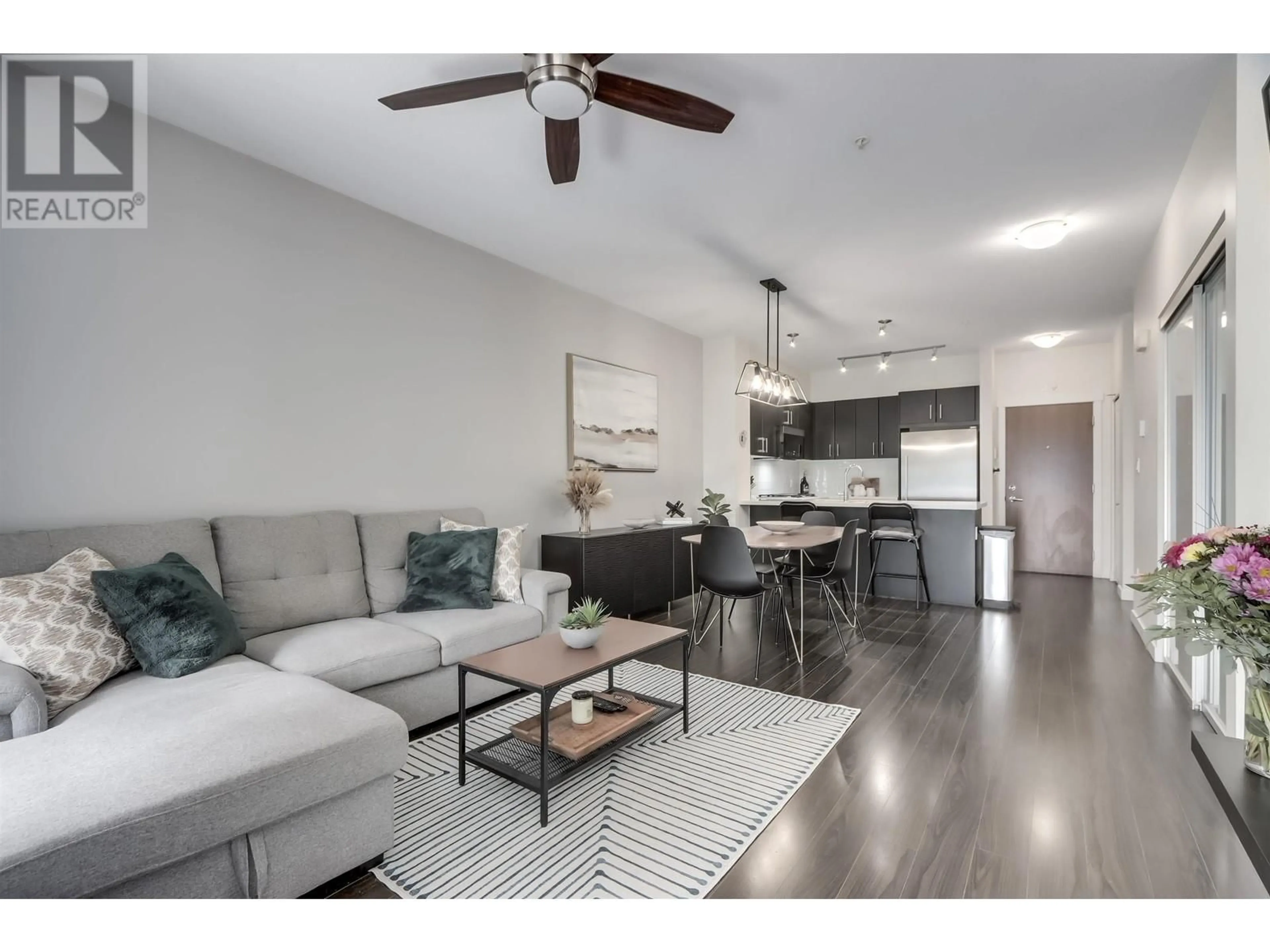 Living room with furniture, wood/laminate floor for 107 - 3163 RIVERWALK AVENUE, Vancouver British Columbia V5S0A8