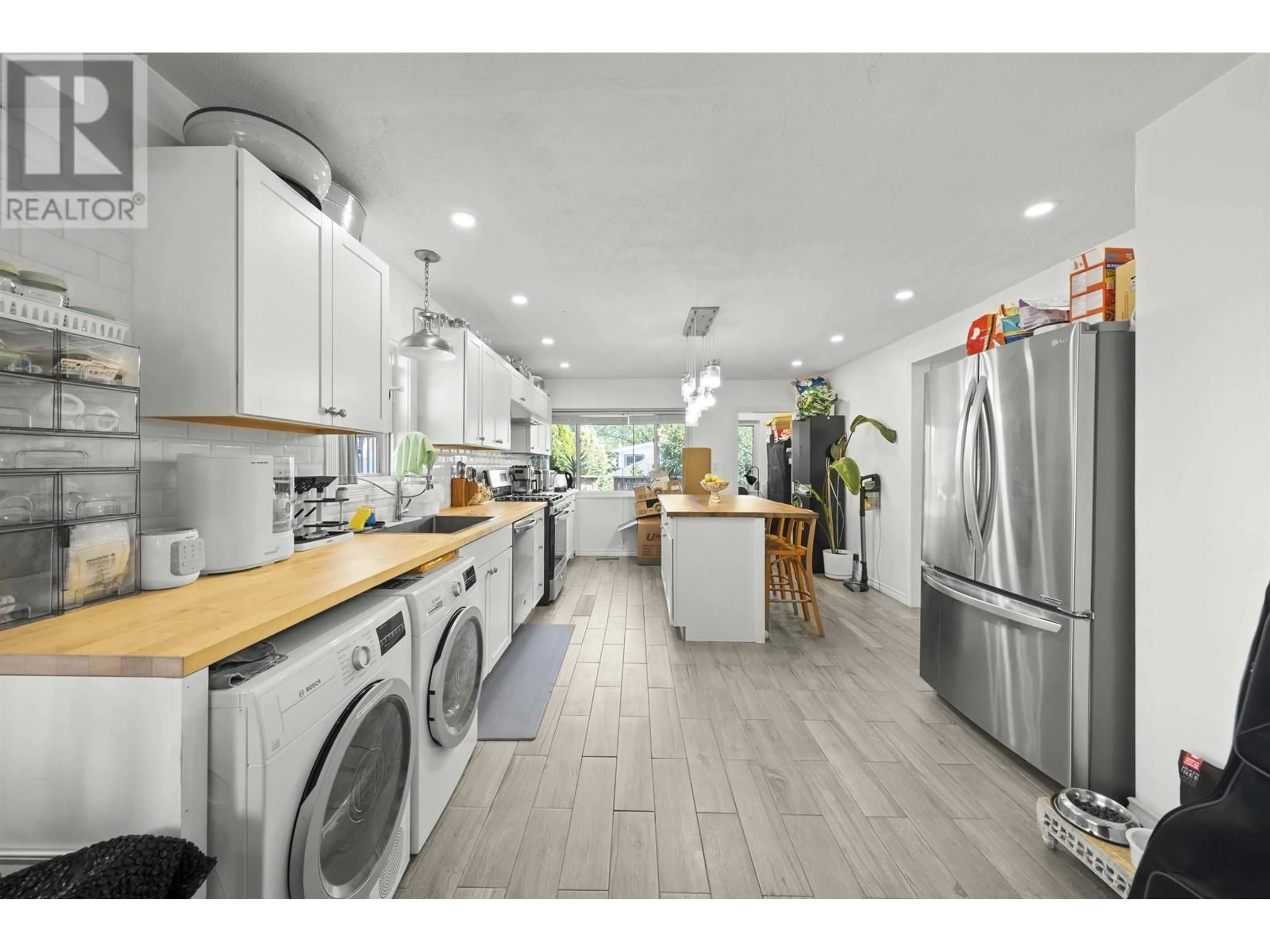 Open concept kitchen, wood/laminate floor for 2647 DUNDAS STREET, Vancouver British Columbia V5K1R1