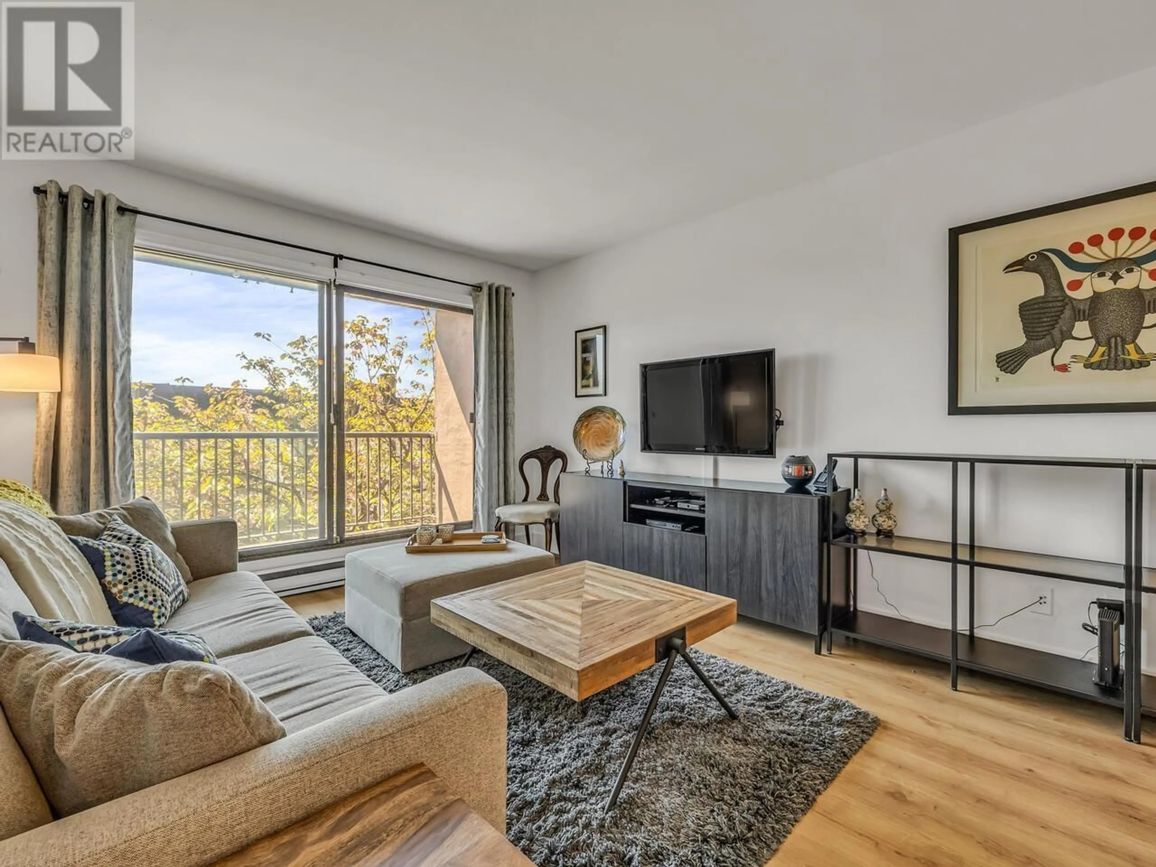 Living room with furniture, wood/laminate floor for 206 - 251 4TH STREET, North Vancouver British Columbia V7M1H8