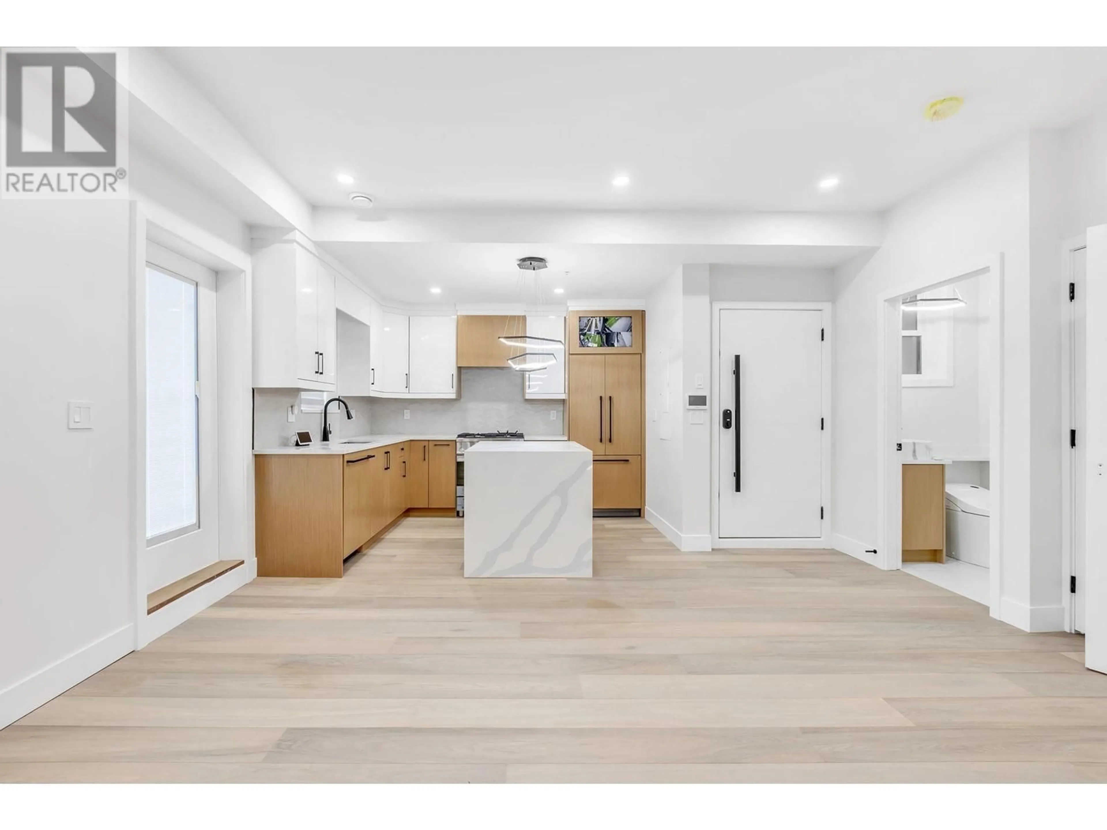 Open concept kitchen, wood/laminate floor for 3440 4TH AVENUE, Vancouver British Columbia V5M1L9