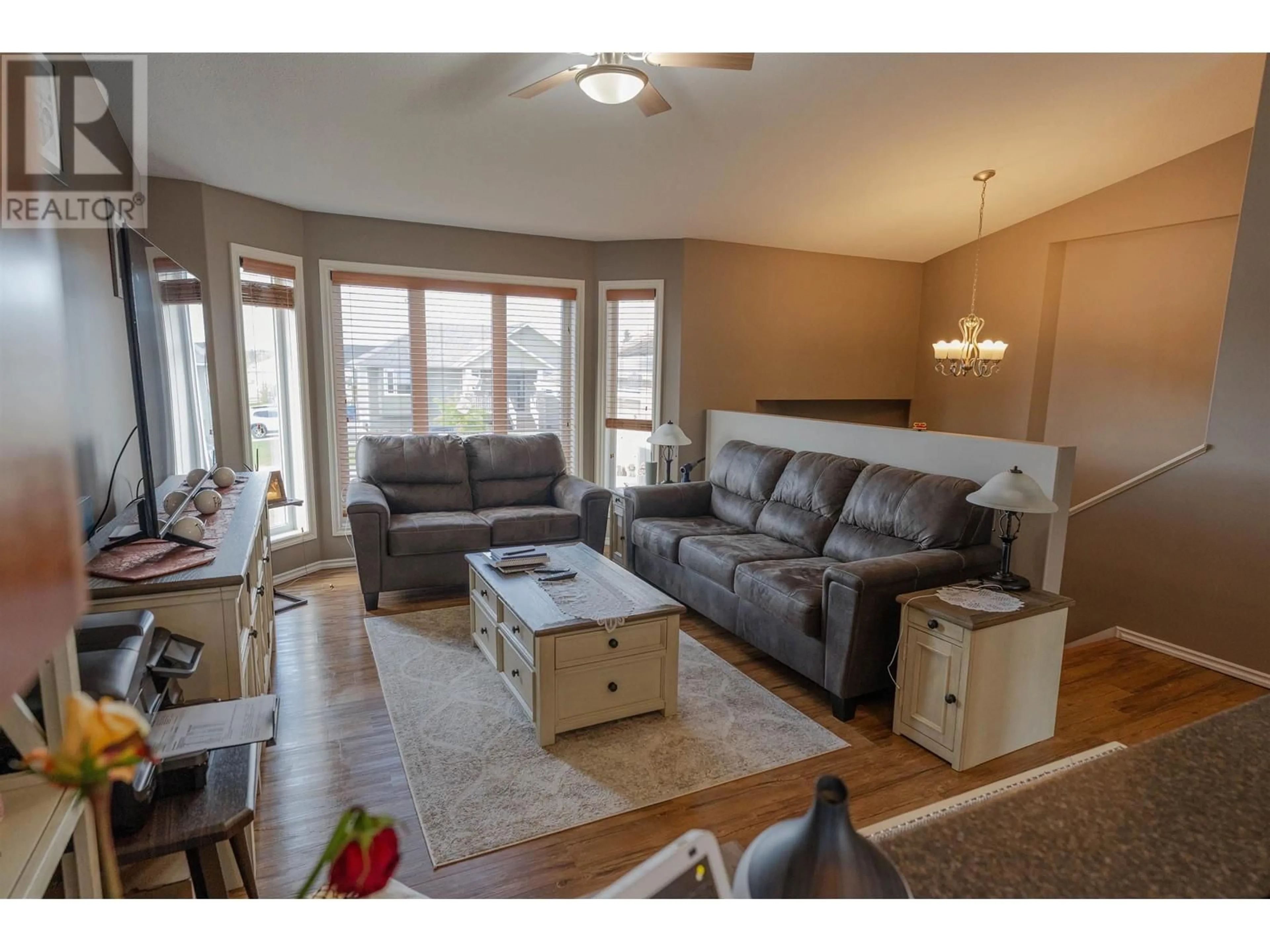 Living room with furniture, wood/laminate floor for 9627 113 AVENUE, Fort St. John British Columbia V1J7J1