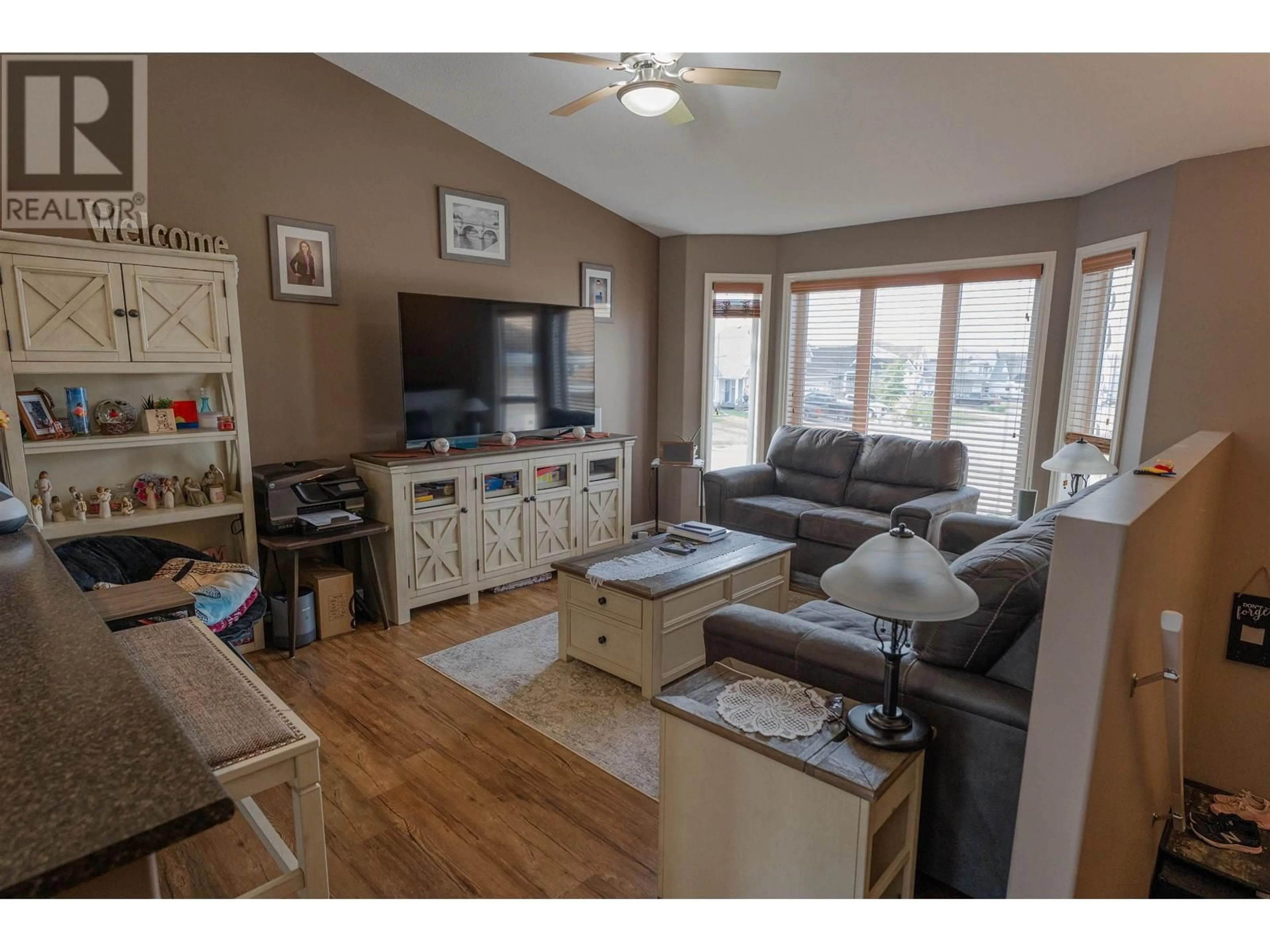 Living room with furniture, wood/laminate floor for 9627 113 AVENUE, Fort St. John British Columbia V1J7J1