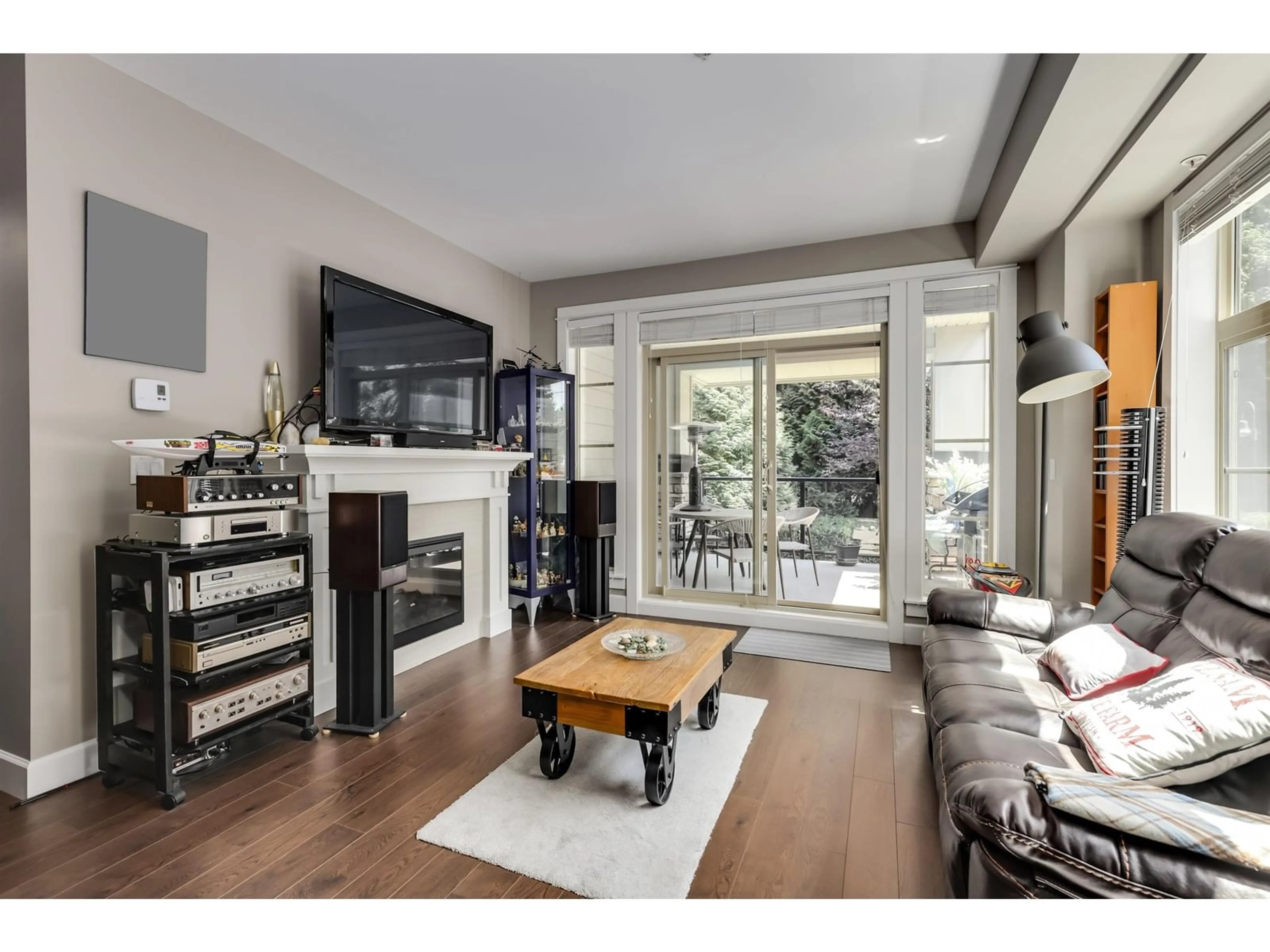 Living room with furniture, wood/laminate floor for 205 - 15185 36, Surrey British Columbia V3Z4R3