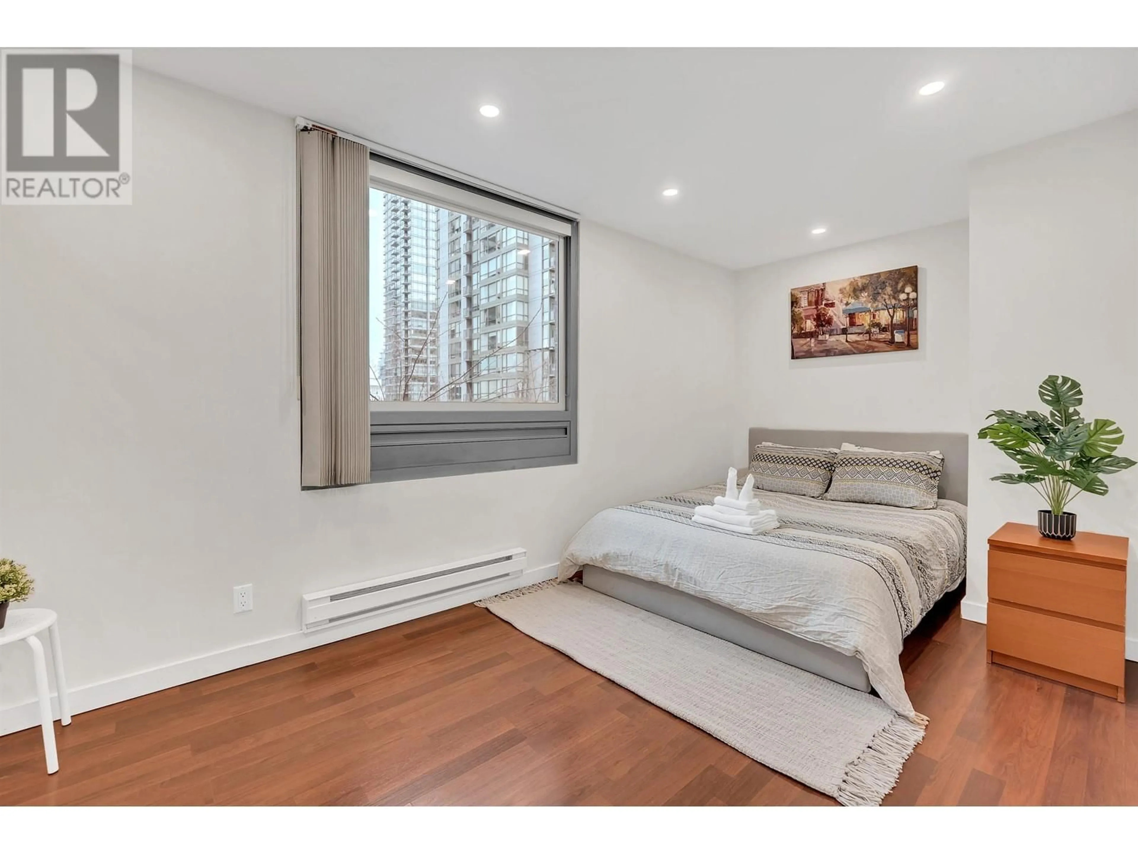 Bedroom with bed, wood/laminate floor for 304 - 1288 GEORGIA STREET, Vancouver British Columbia V6E4R3