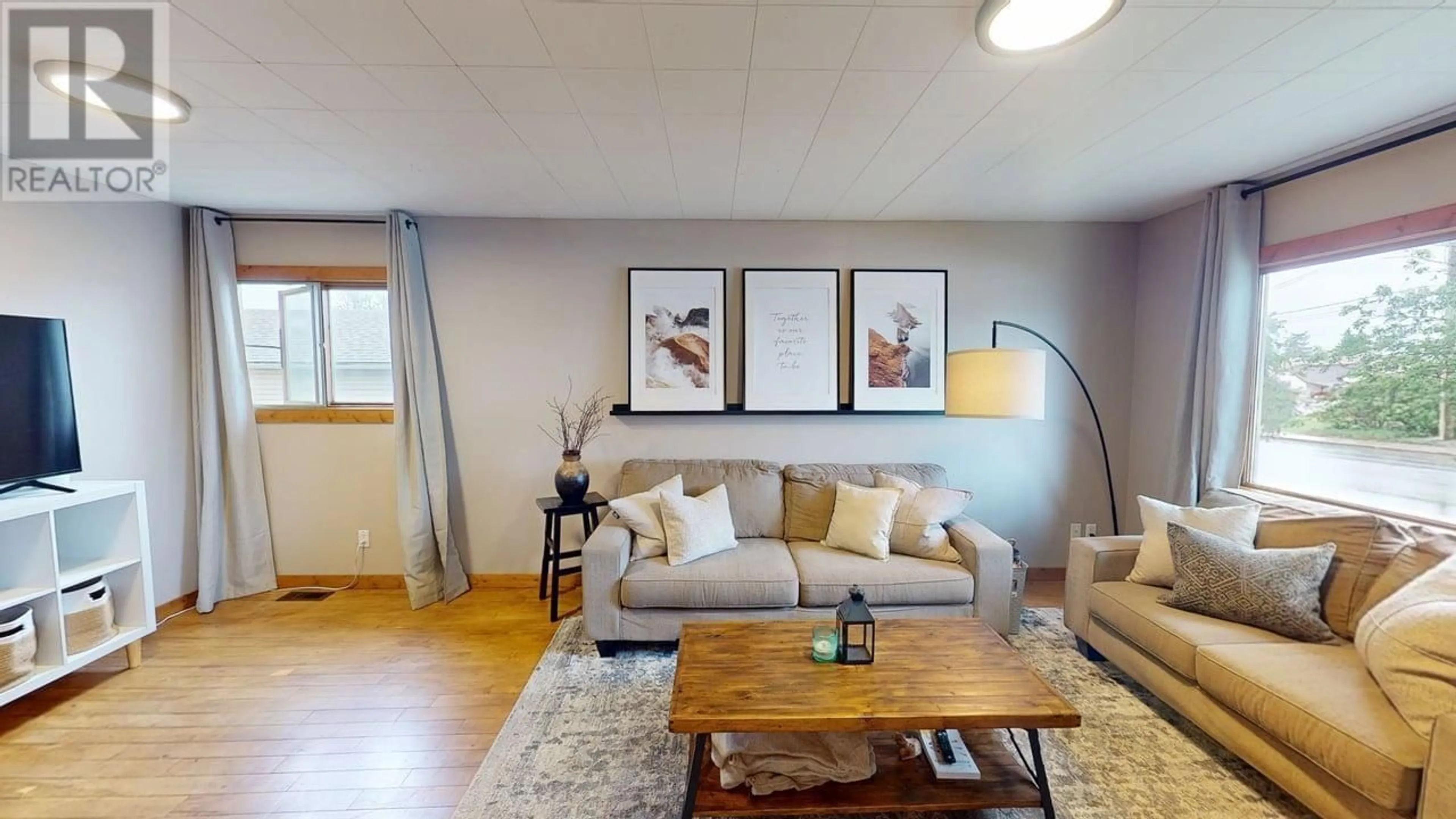 Living room with furniture, wood/laminate floor for 9711 102 STREET, Fort St. John British Columbia V1J4B1