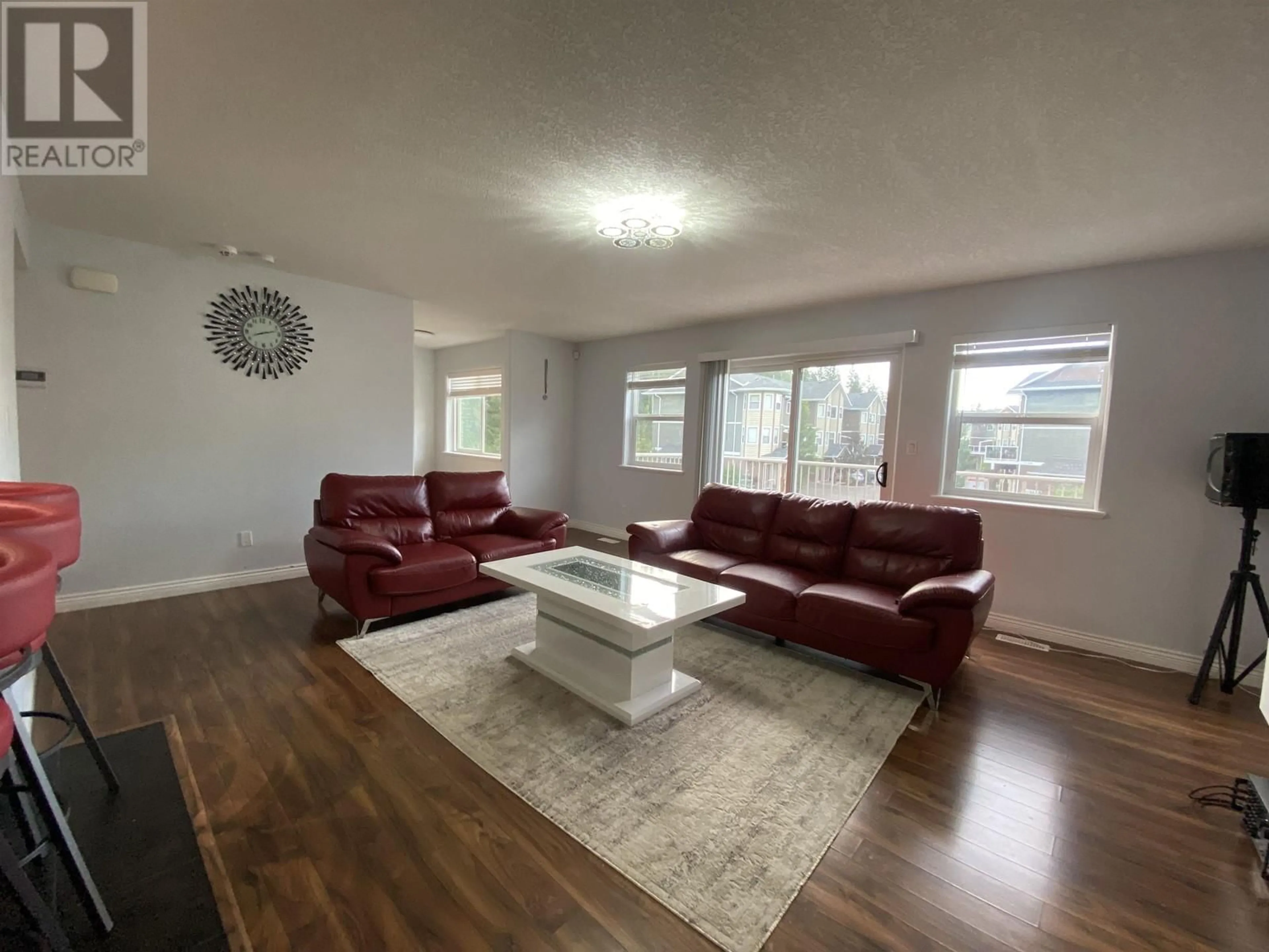 Living room with furniture, wood/laminate floor for 7415 CREEKSIDE WAY, Prince George British Columbia V2N0C2