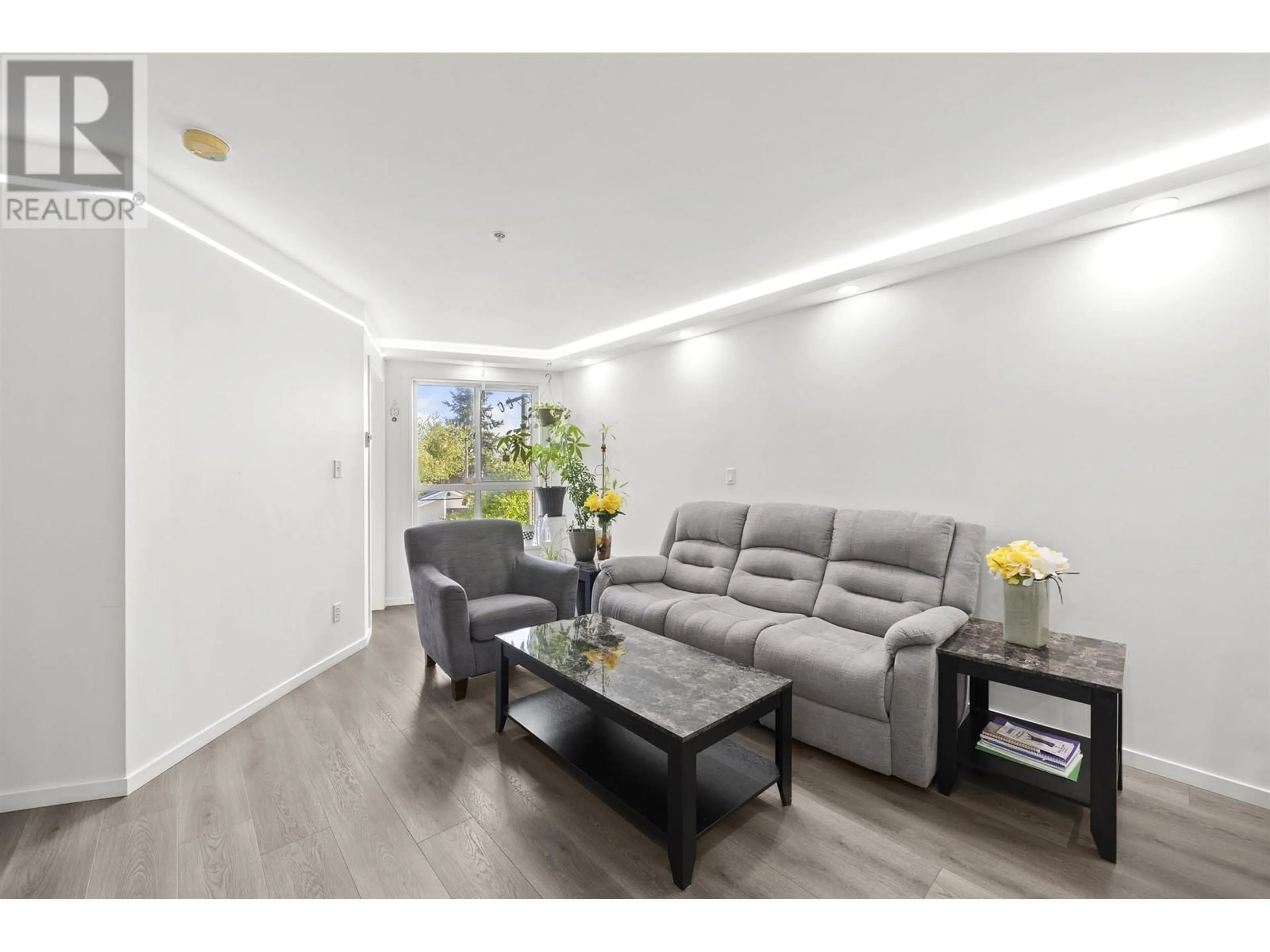 Living room with furniture, wood/laminate floor for 307 - 5438 RUPERT STREET, Vancouver British Columbia V5R2K3