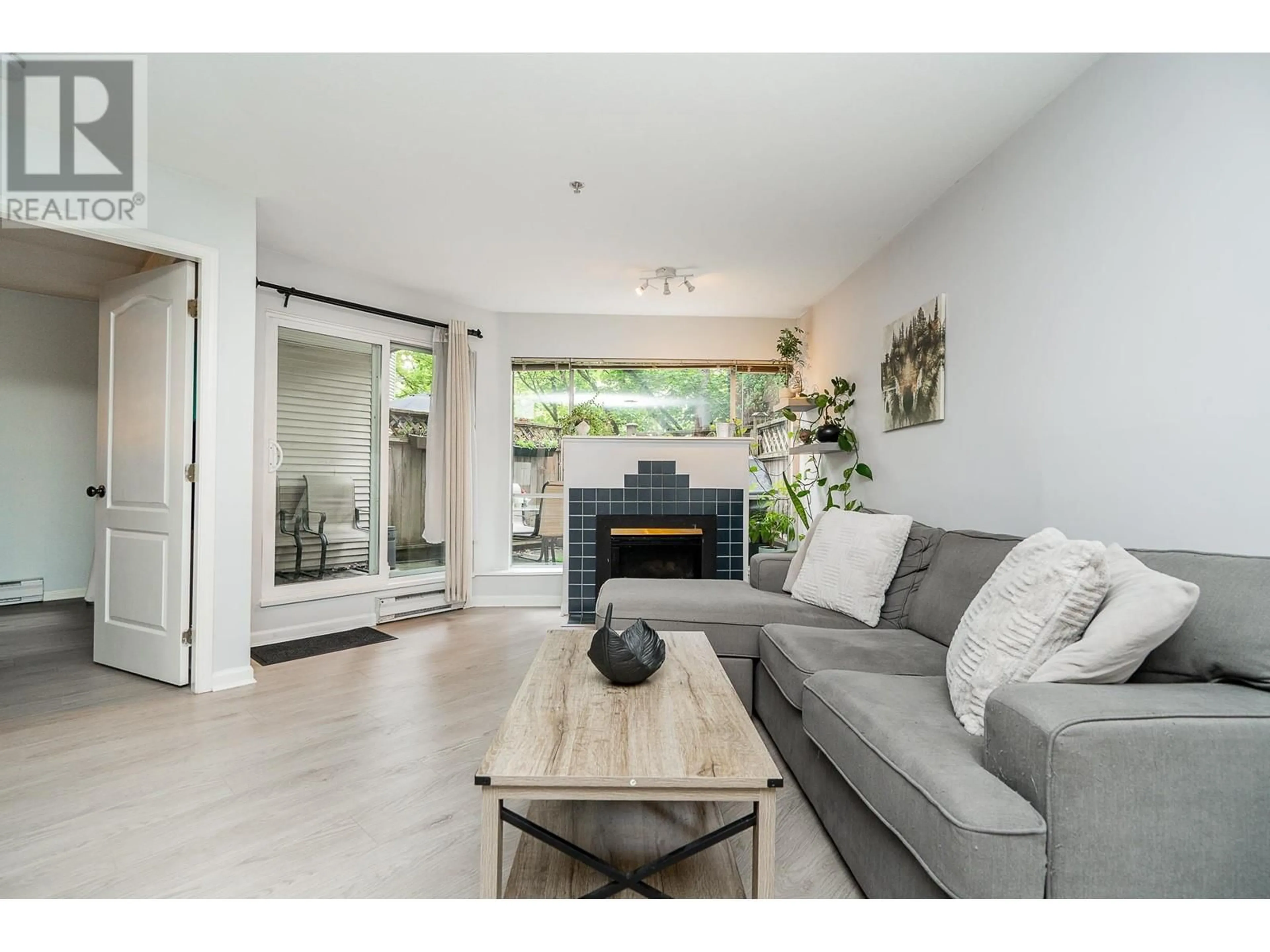 Living room with furniture, wood/laminate floor for 111 - 2401 HAWTHORNE AVENUE, Port Coquitlam British Columbia V3C6R9